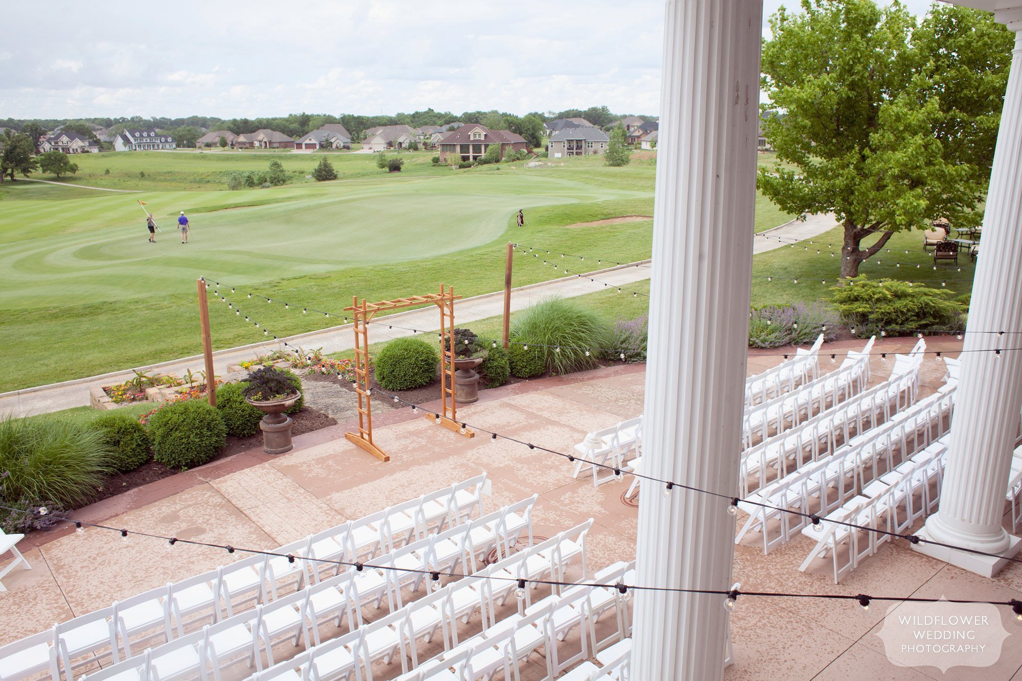 View of the outdoor patio for a wedding ceremony at the Old Hawthorne Country Club venue in Columbia, MO.