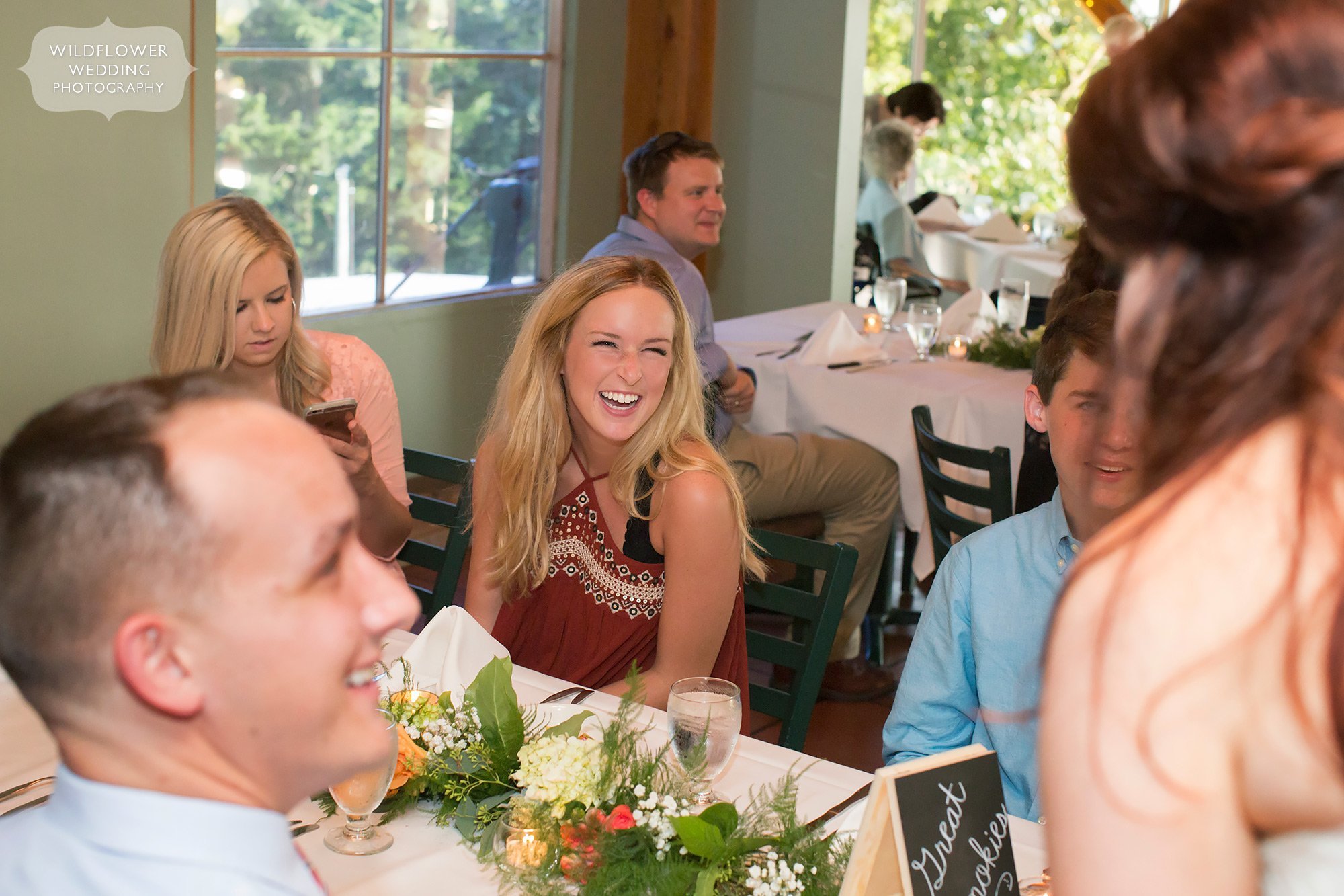 Wedding guests smiling and talking during wedding reception at Les Bourgeois Winery in MO.