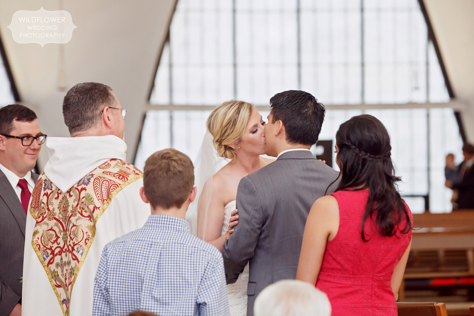 Bride and groom kiss at their St. Anselm wedding in St. Louis, MO.