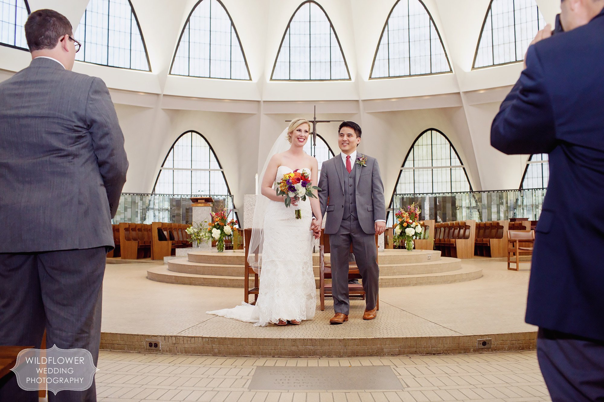 Bride and groom stand on the alter after their ceremony at St. Anslem's Church at the Priory in St. Louis.