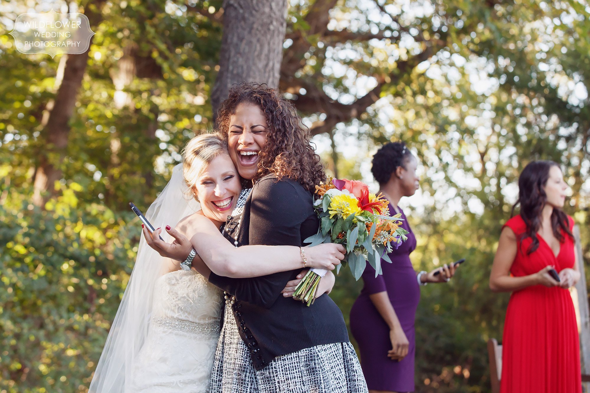Great documentary wedding photo of the bride laughing and smiling with an old friend.