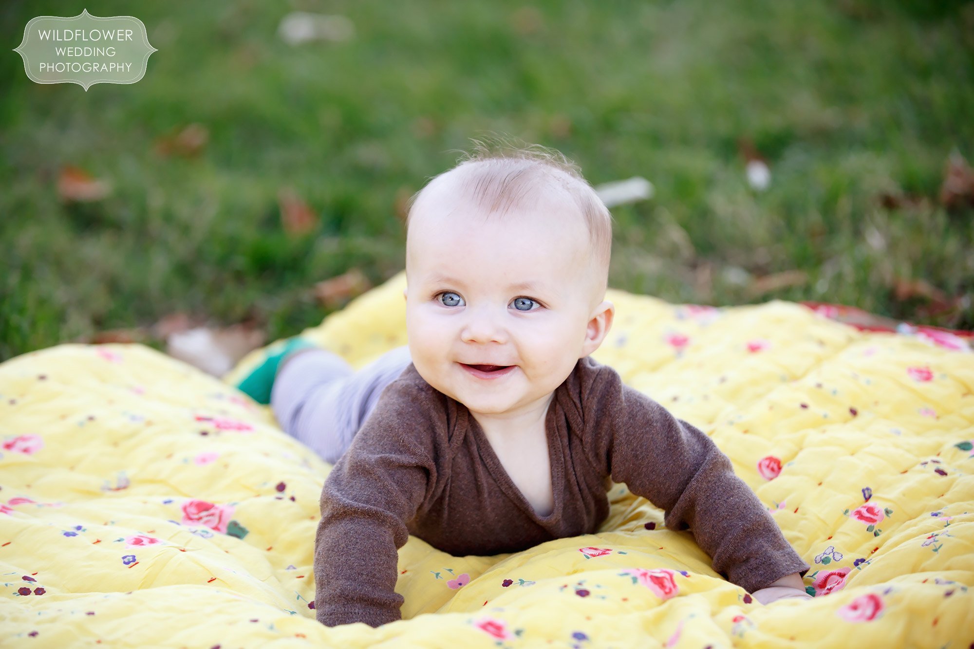 Cute baby picture of tummy time on a yellow blanket at Loose Park in MO.