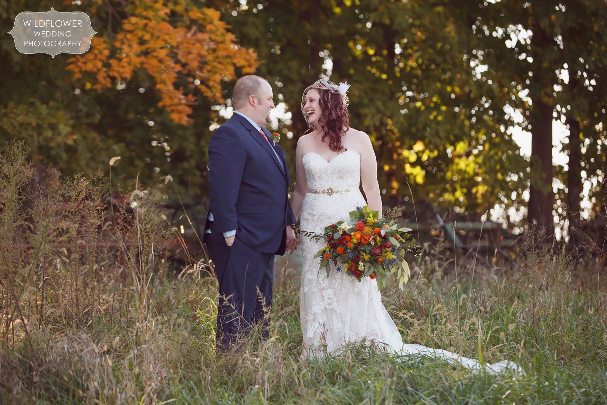 Bride and groom stand in a field before their Schwinn Produce Farm fall wedding in KS.