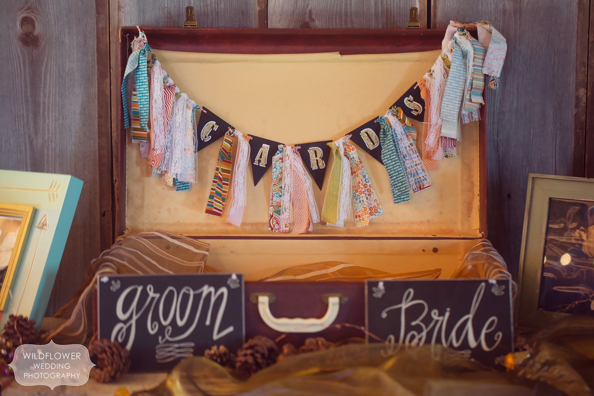 A vintage suitcase is repurposed as wedding decor for cards and gifts at this barn wedding in KC.