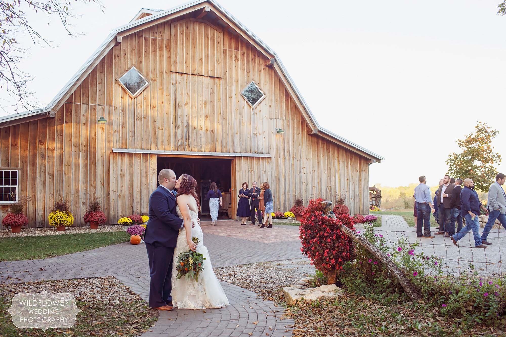 View of the Schwinn Produce Farm and a bride and groom kissing in front of the large reception barn.
