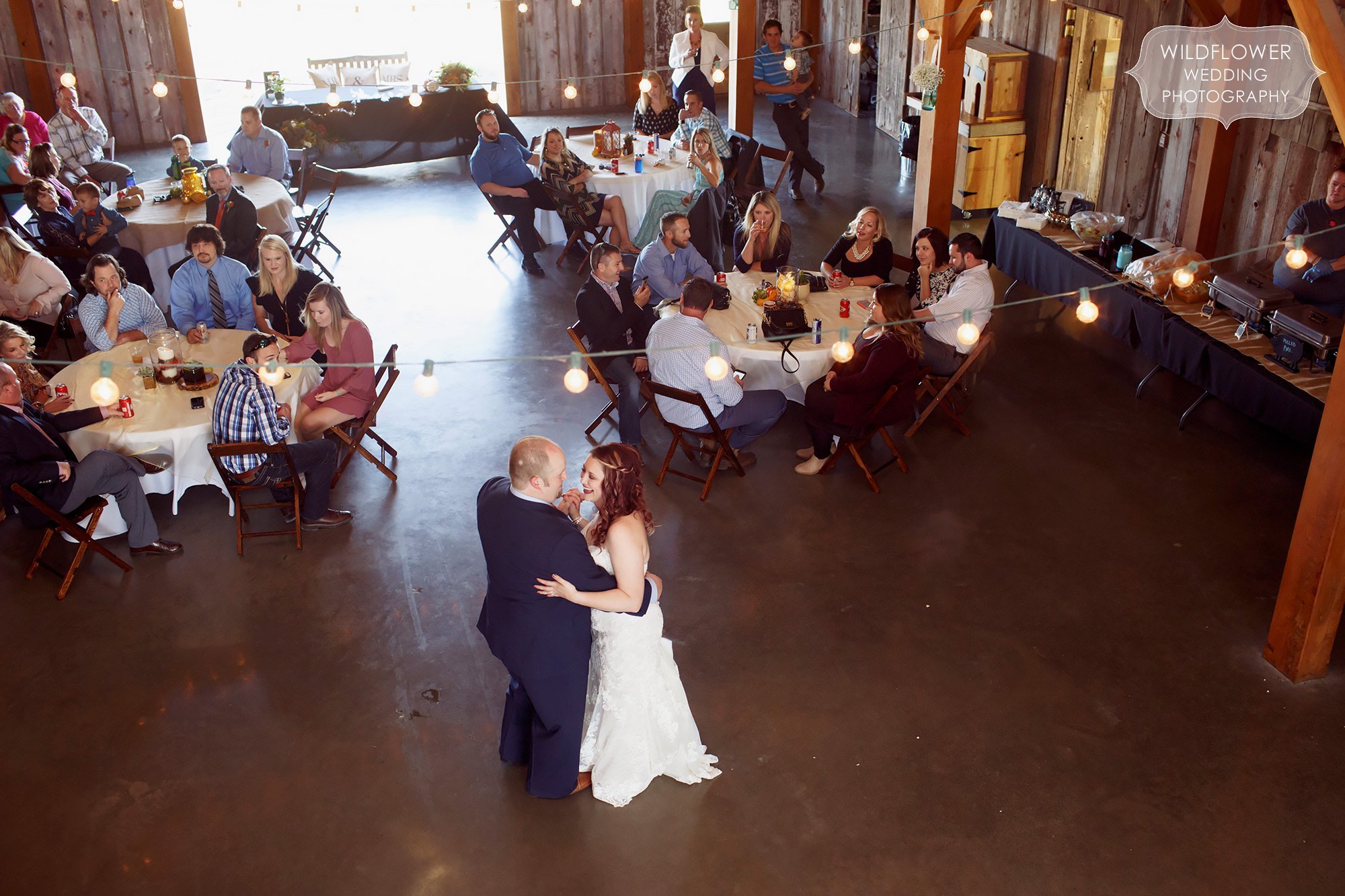 First dance with cafe lights at this barn wedding in KS.