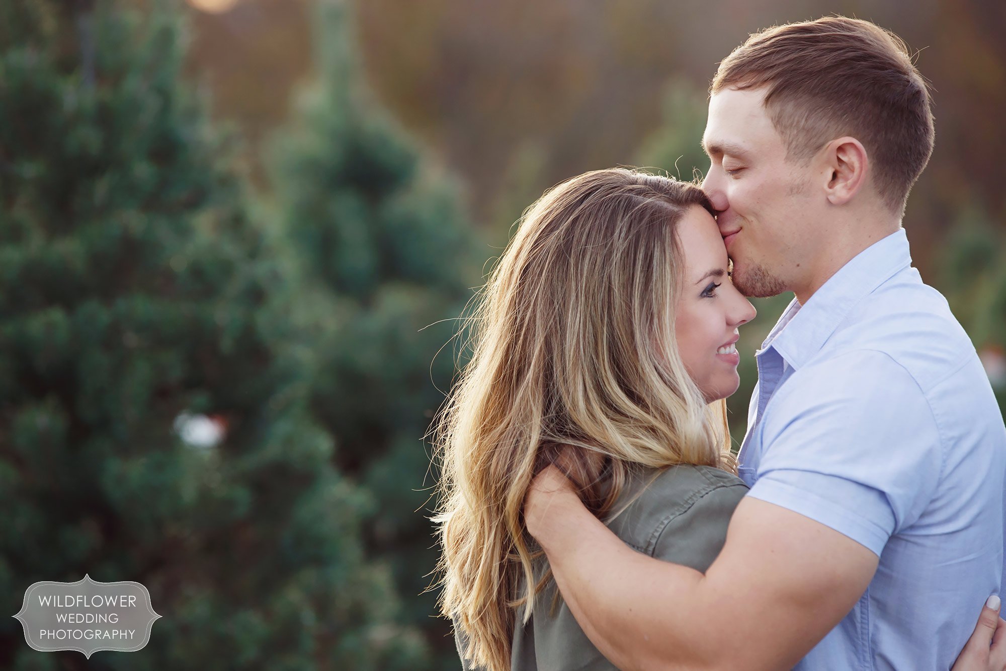 Sexy photo of the guys kissing the girl's forehead during this winter engagement session in Columbia, MO.