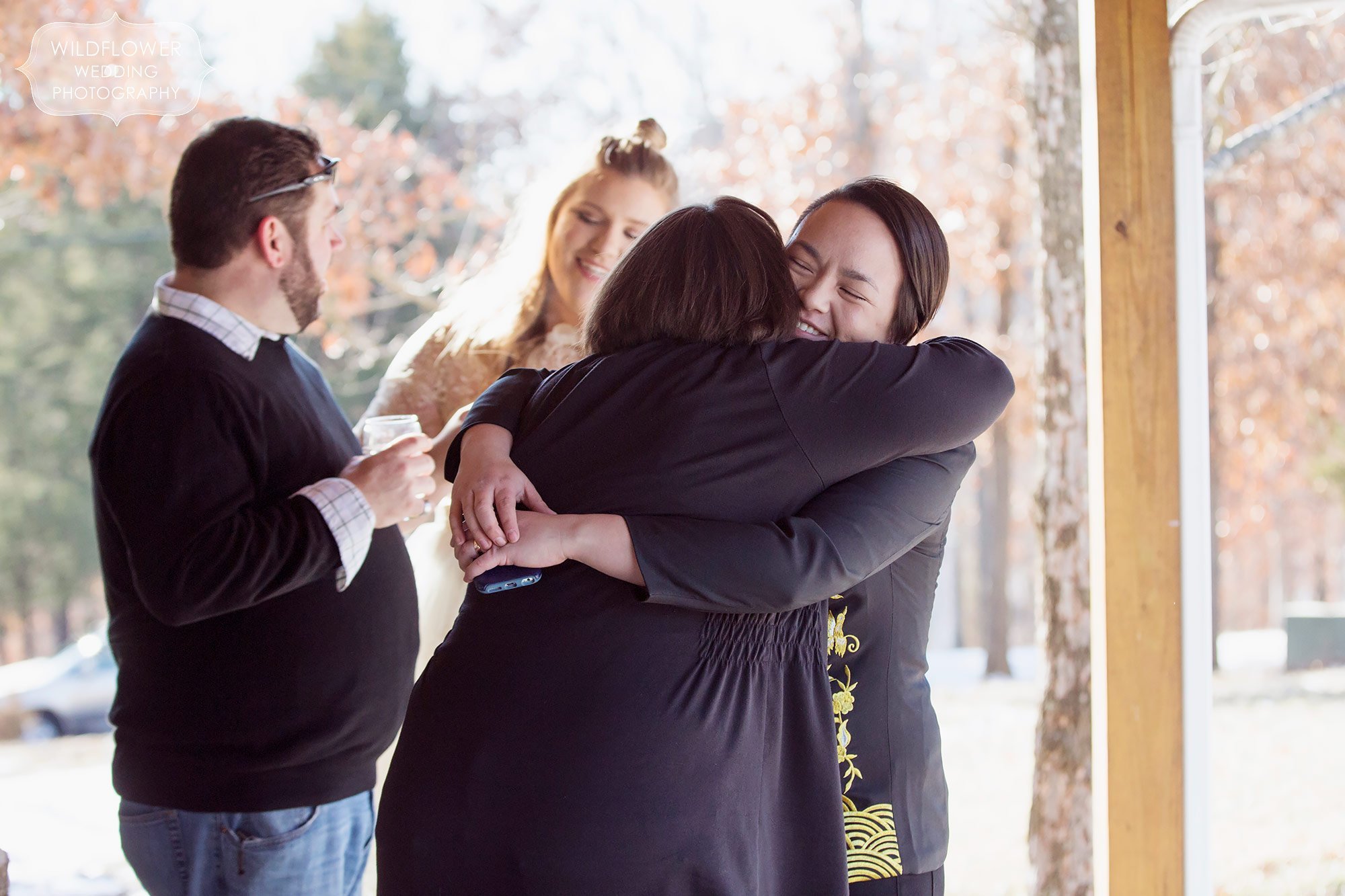 This couple hugs supportive friends after their gay wedding ceremony in mid-MO.