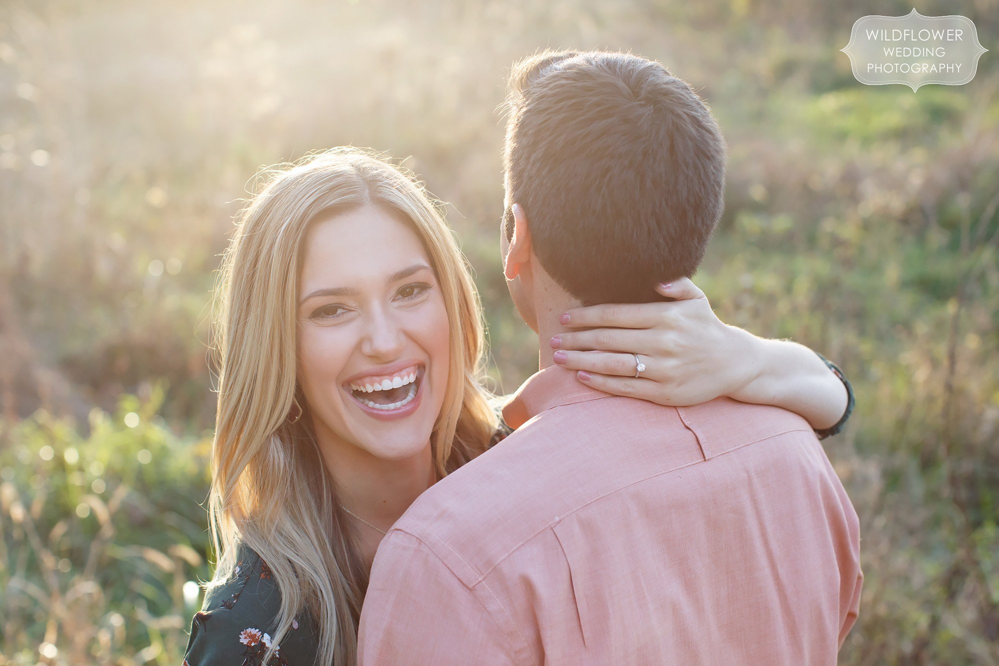 Gorgeous natural engagement photo of the girl laughing during their sunset photo shoot at Grindstone in Columbia, MO.
