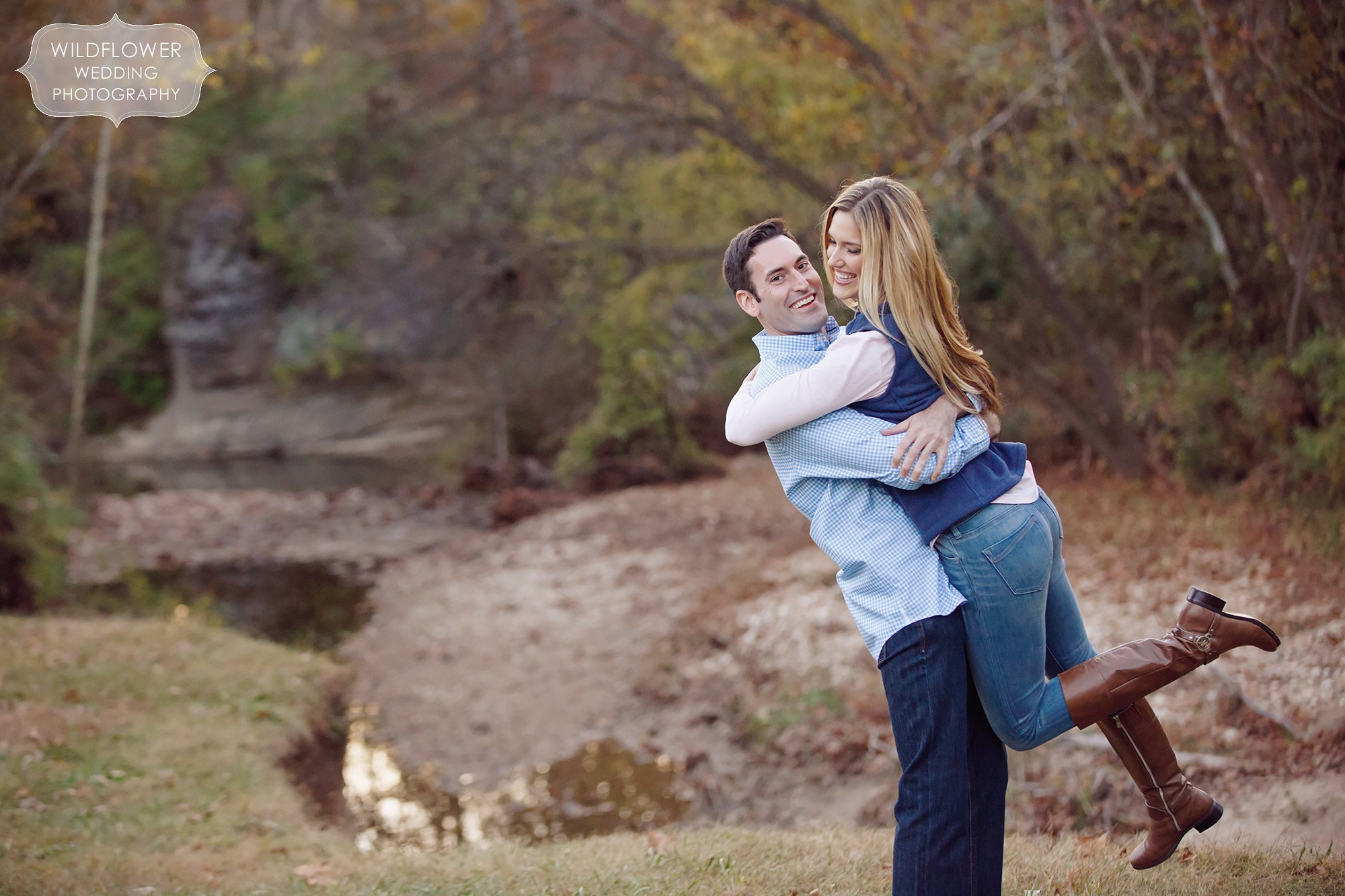 Fun engagement photo of the guy picking up the girl laughing at Grindstone Park in Columbia, MO.