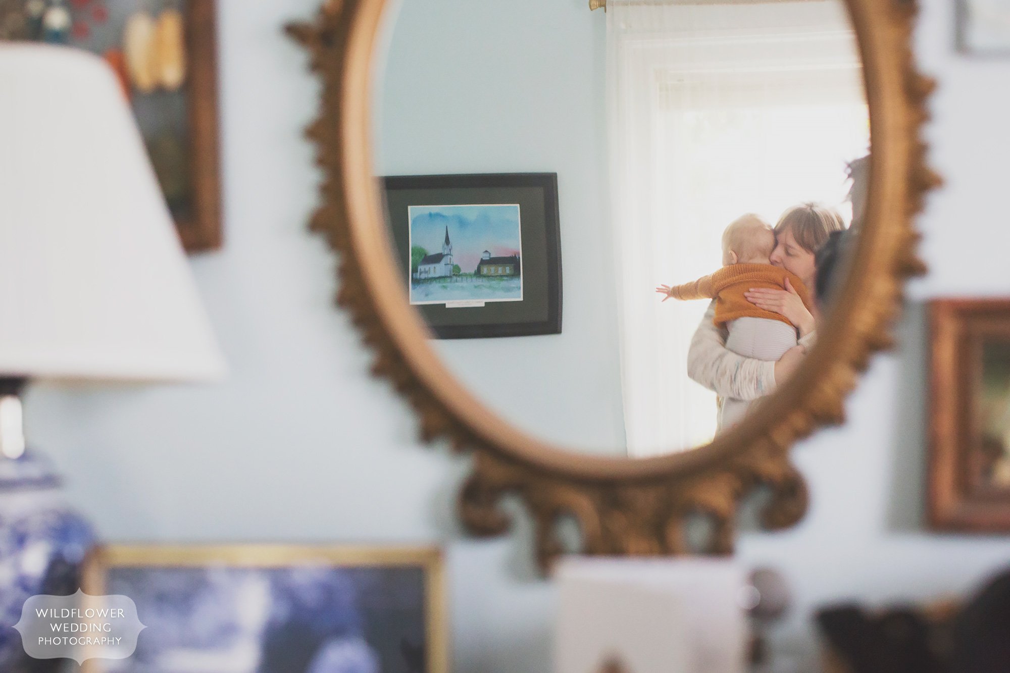Artsy baby photo of the mom and baby reflected in the mirror at home in Columbia, MO.
