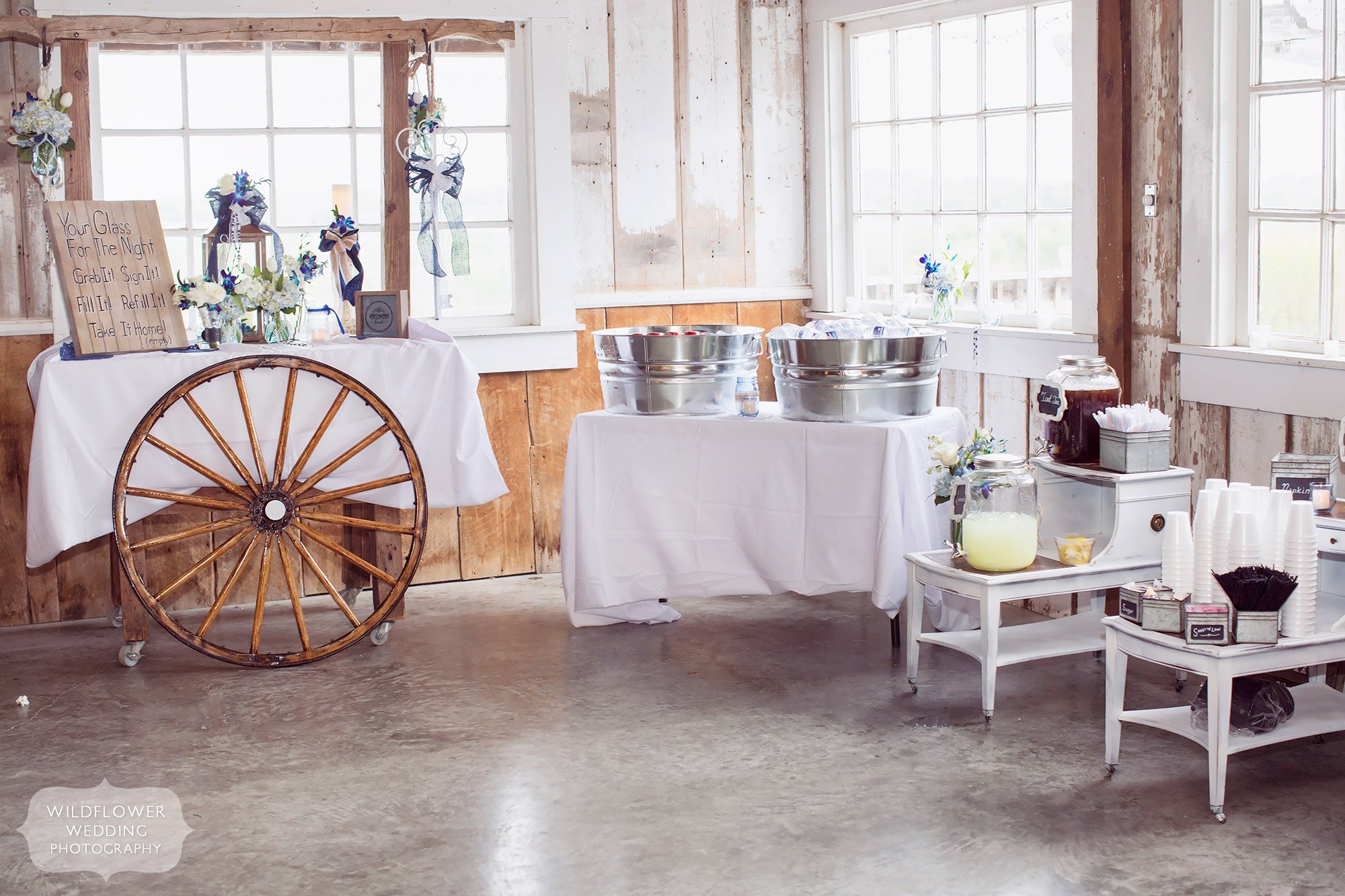 Great ideas for farm wedding decor with a wagon wheel and lemonade table.