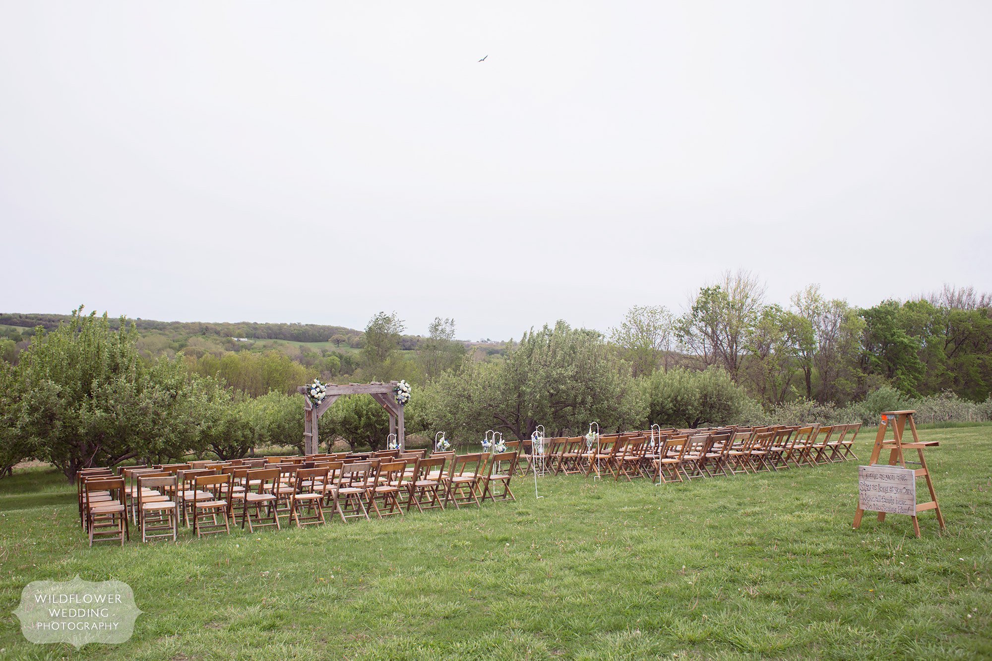 Scenic outdoor location for a wedding ceremony set in the apple orchard at the Weston Red Barn Farm.