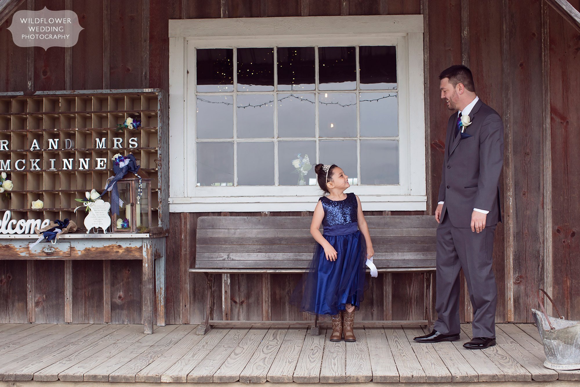 Documentary wedding photography of the groom seeing the flower girl outside of the barn in Weston, MO.