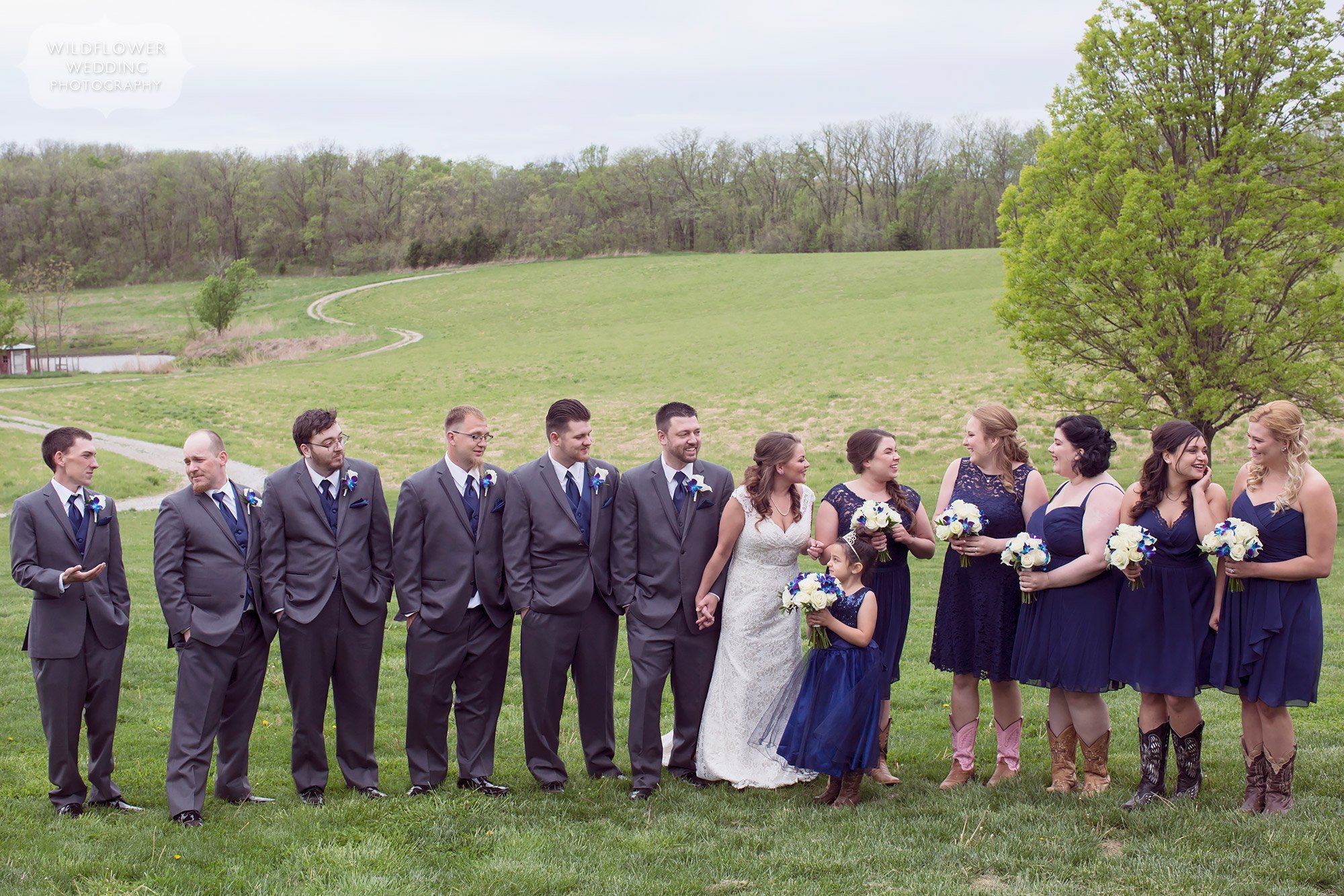 Photo of the large wedding party laughing at this farm wedding in Weston.