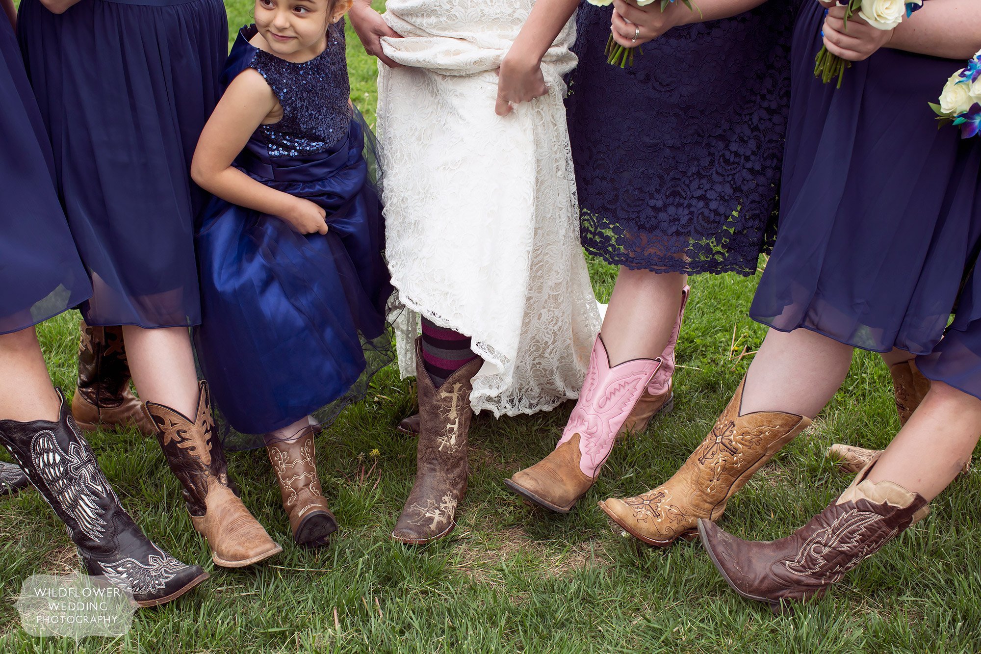 Bridesmaids show off their various cowboy boots for this farm wedding north of Kansas City.