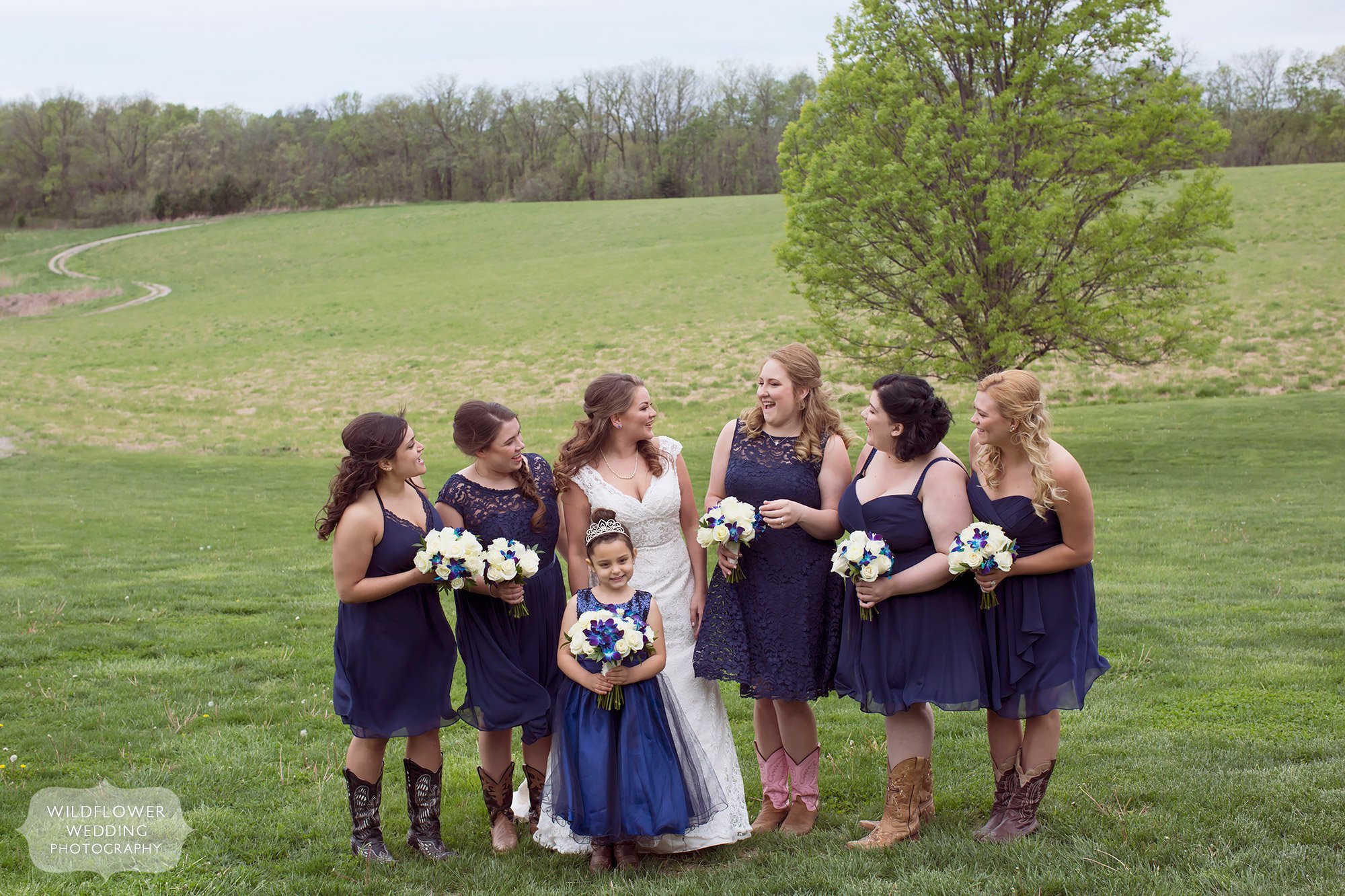 Smiling bridesmaids in navy dresses at this country wedding in Missouri.