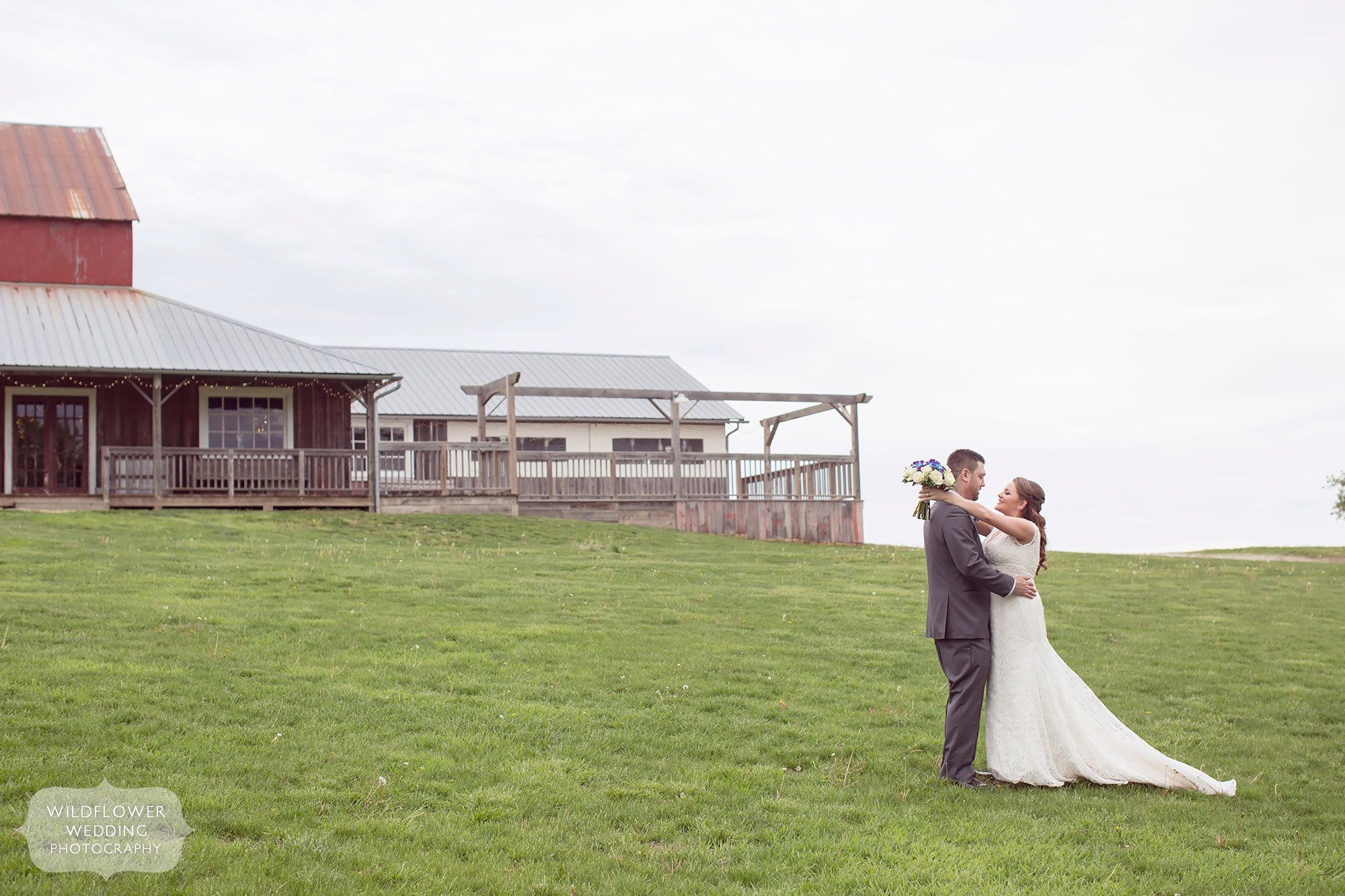 Bride and groom in front of this red barn wedding venue just north of KC.