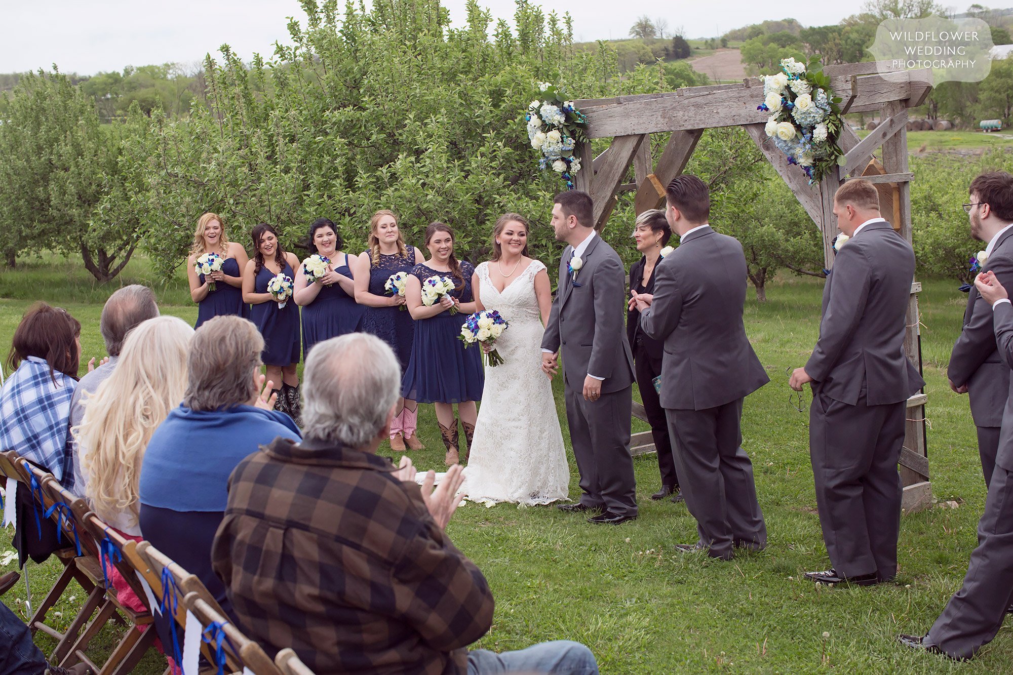 Outdoor wedding ceremony in the orchard in KC.