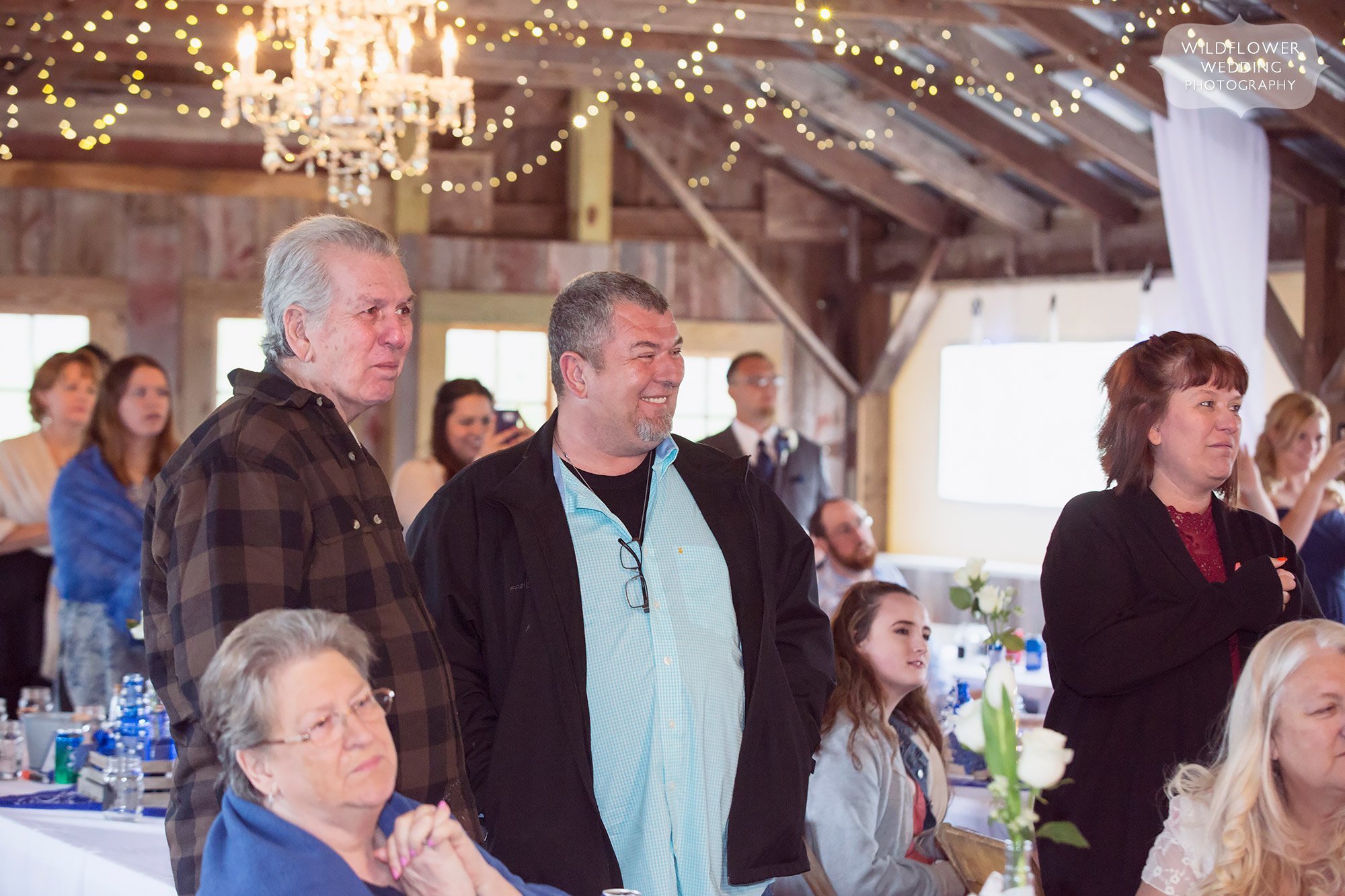 Wedding guests watch the first dance in the red barn in Weston.