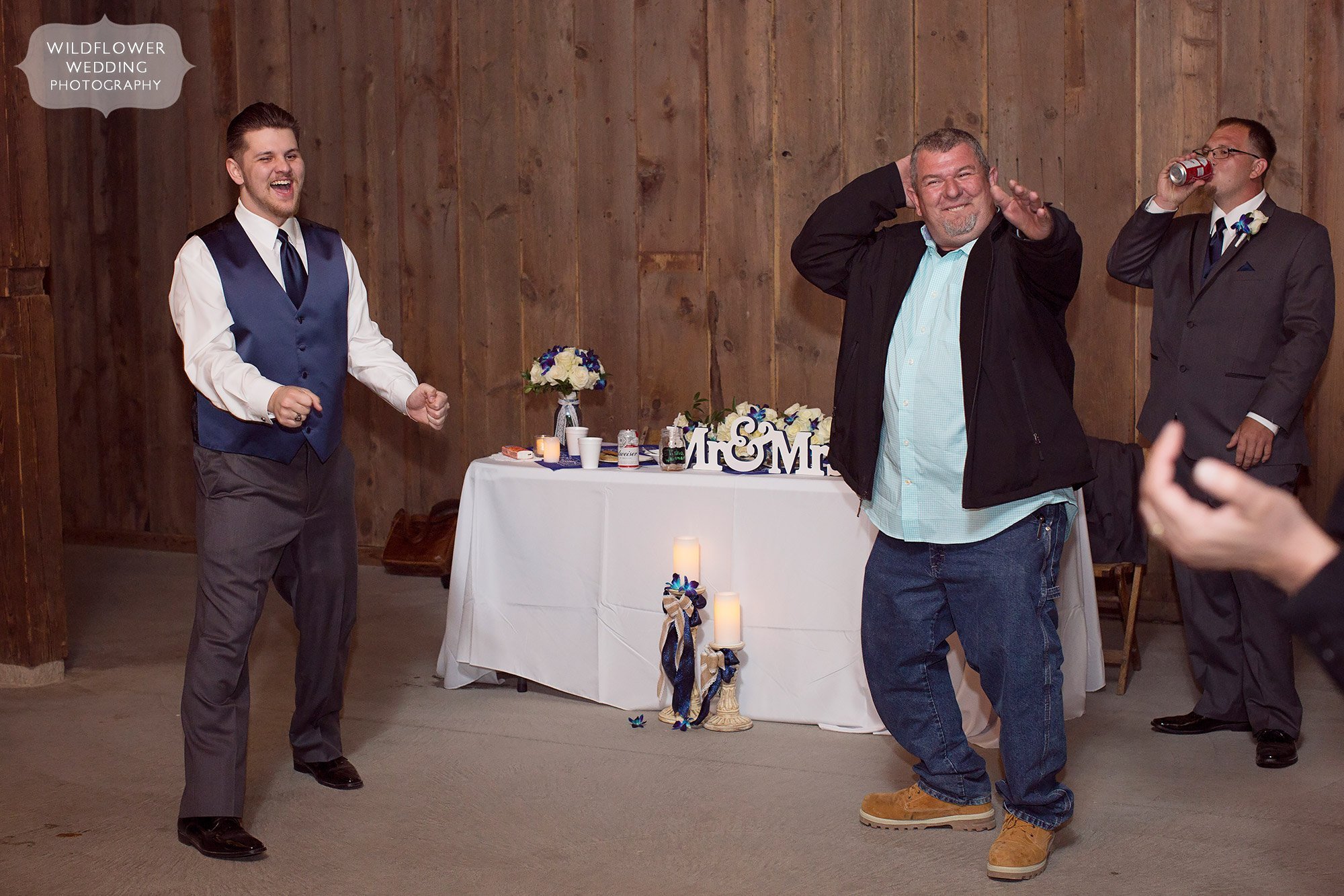 Funny photo of the groomsmen dancing at the Weston Red Barn Farm.