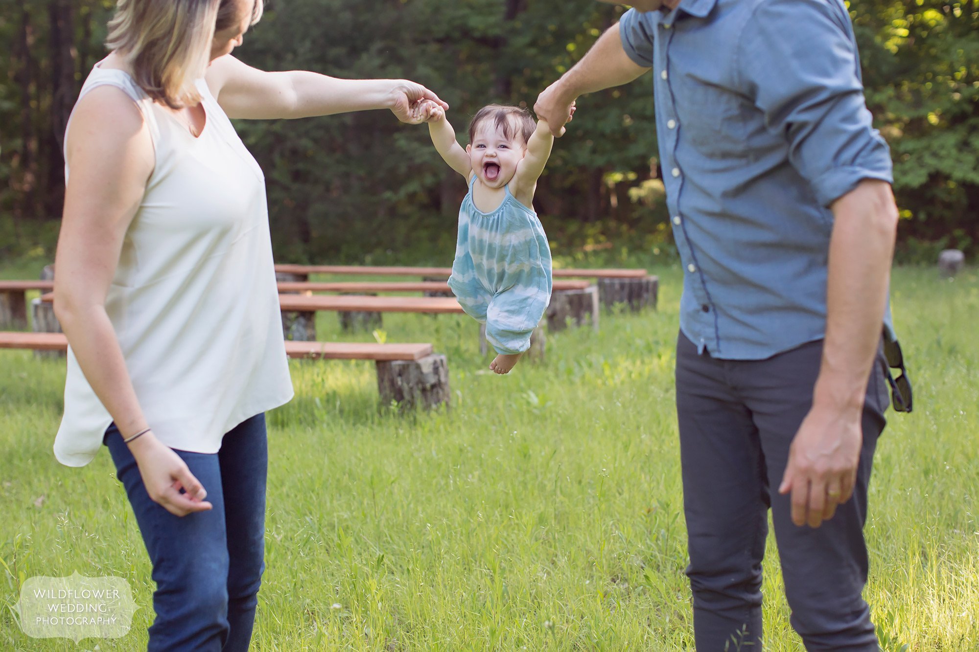 Parents swing their baby in this fun family photography backyard session in Columbia, MO.