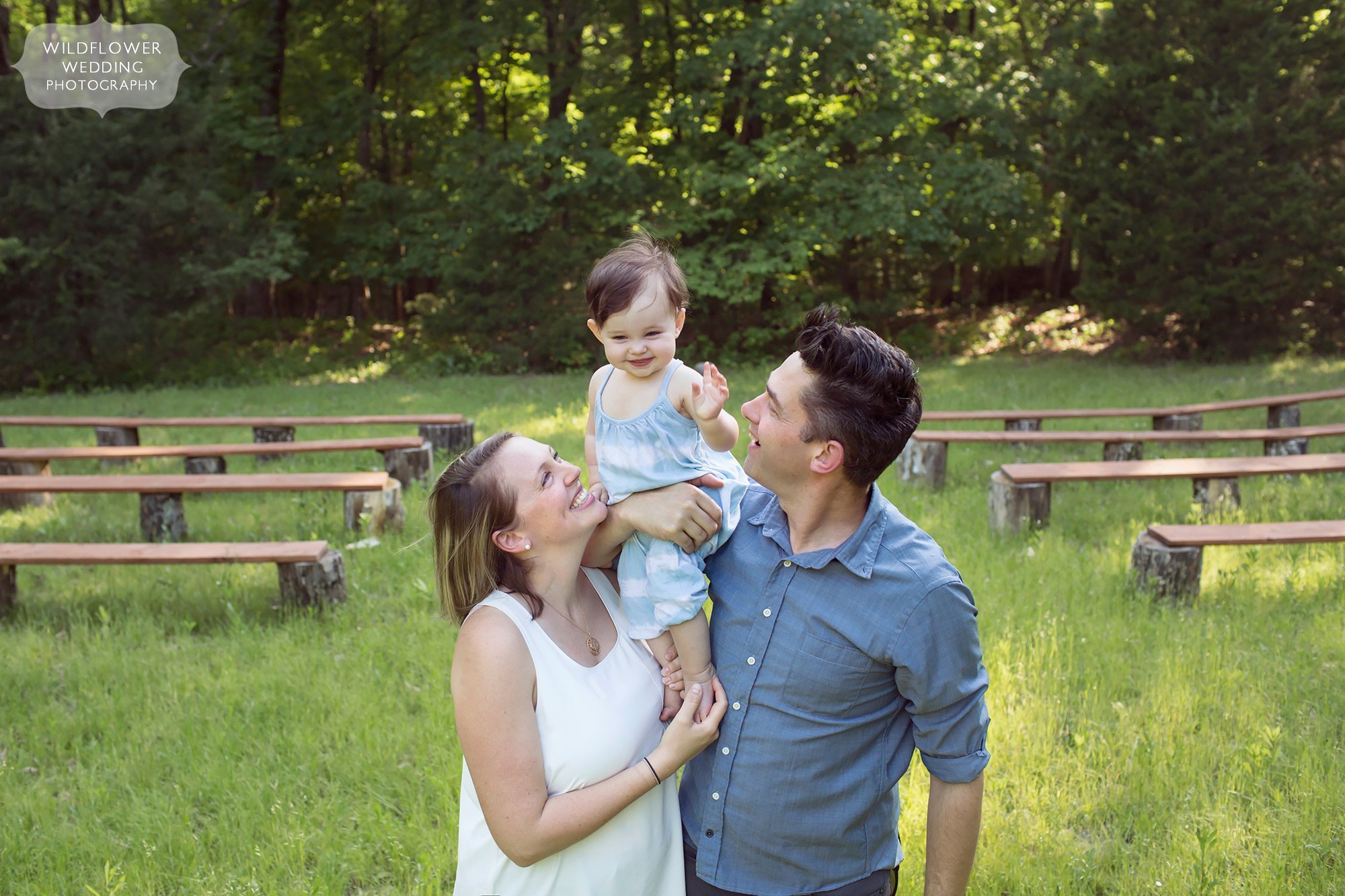 Relaxed portrait of a new family with baby in a field in Columbia, MO.