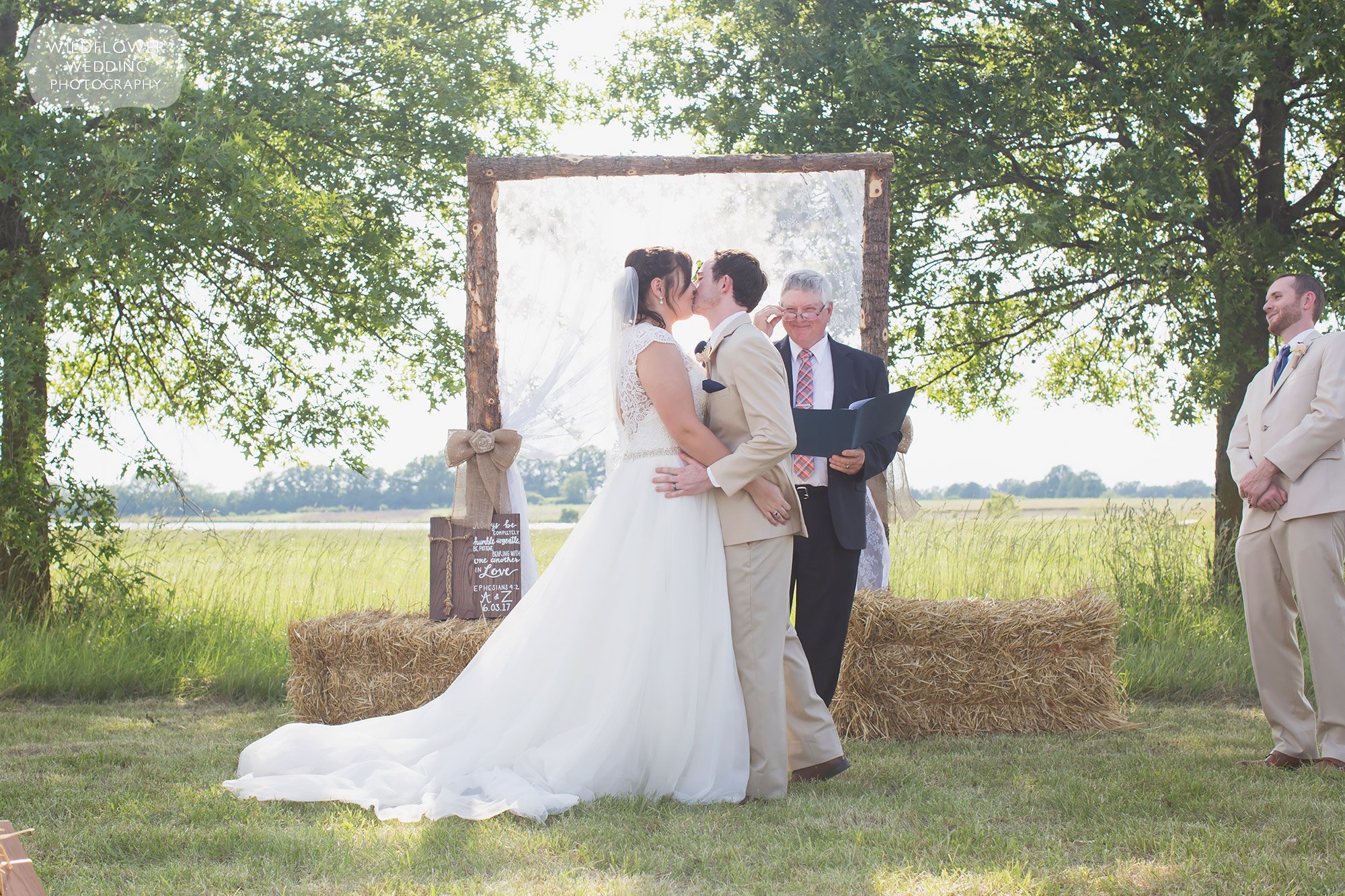 Ceremony kiss during this country wedding in Columbia at Bradford Farm.