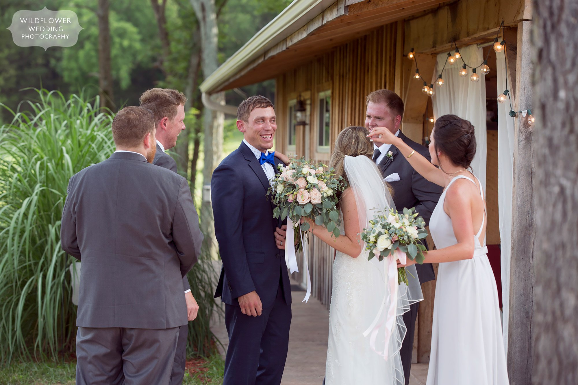 Such a happy photo of the bride and groom's friends congratulating them after the wedding ceremony at Kempker's.