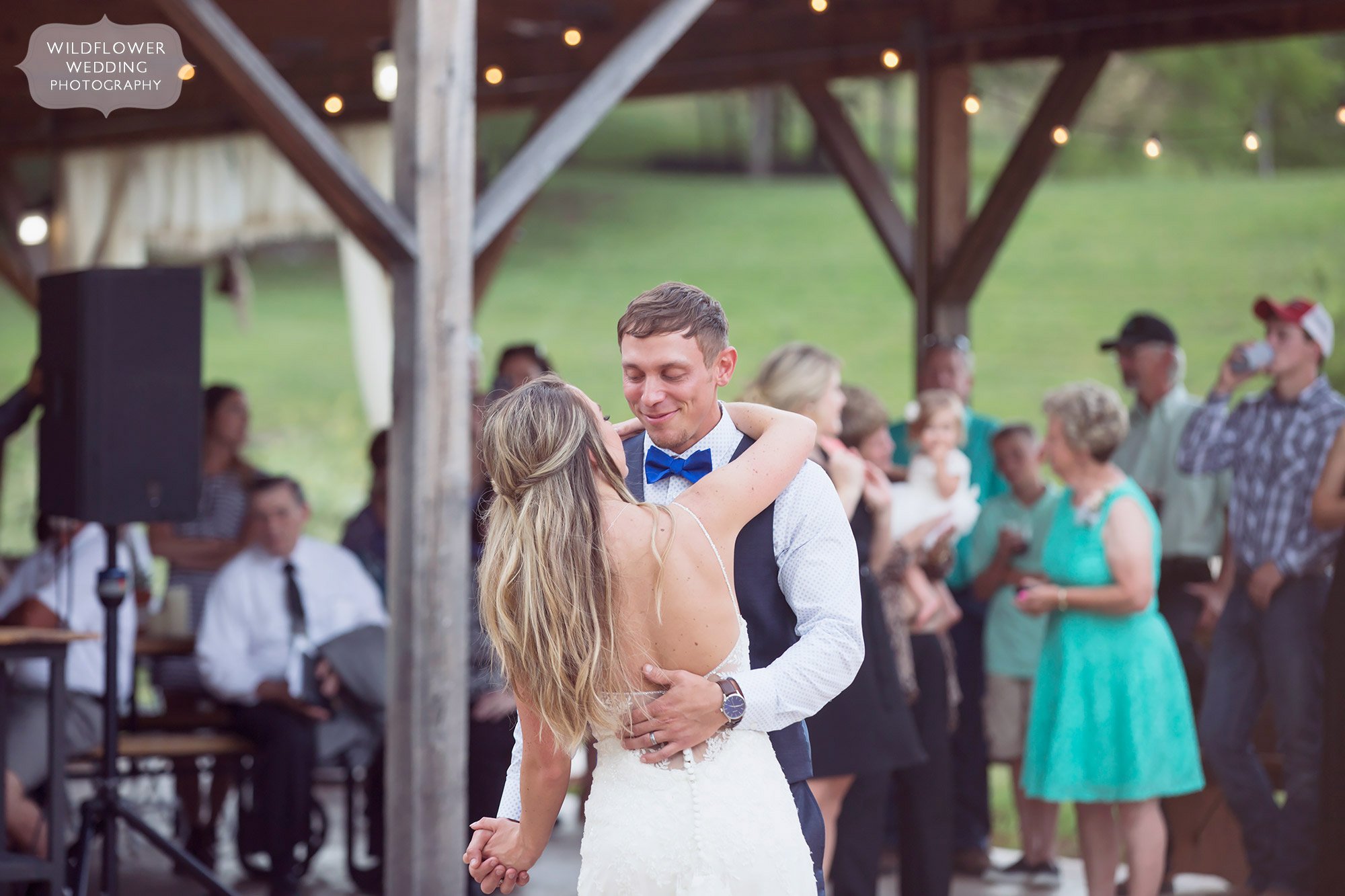 The bride and groom have a romantic first dance during their country barn wedding at the Kempker's Back 40 venue.