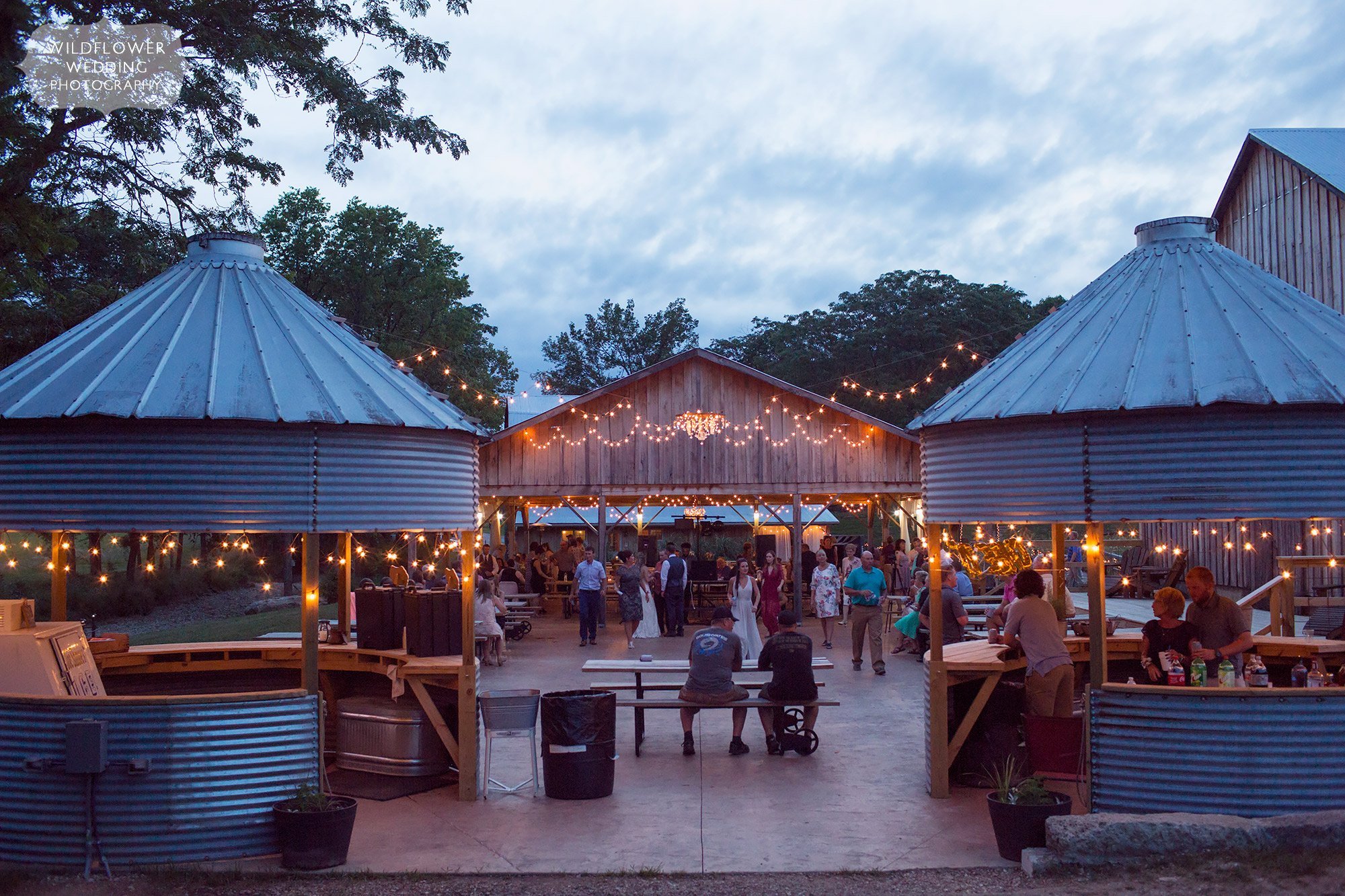 This Kempker's Back 40 Barn wedding in the country had the most beautiful outdoor dancing patio with string lights above and silos as outdoor bars for drinks.