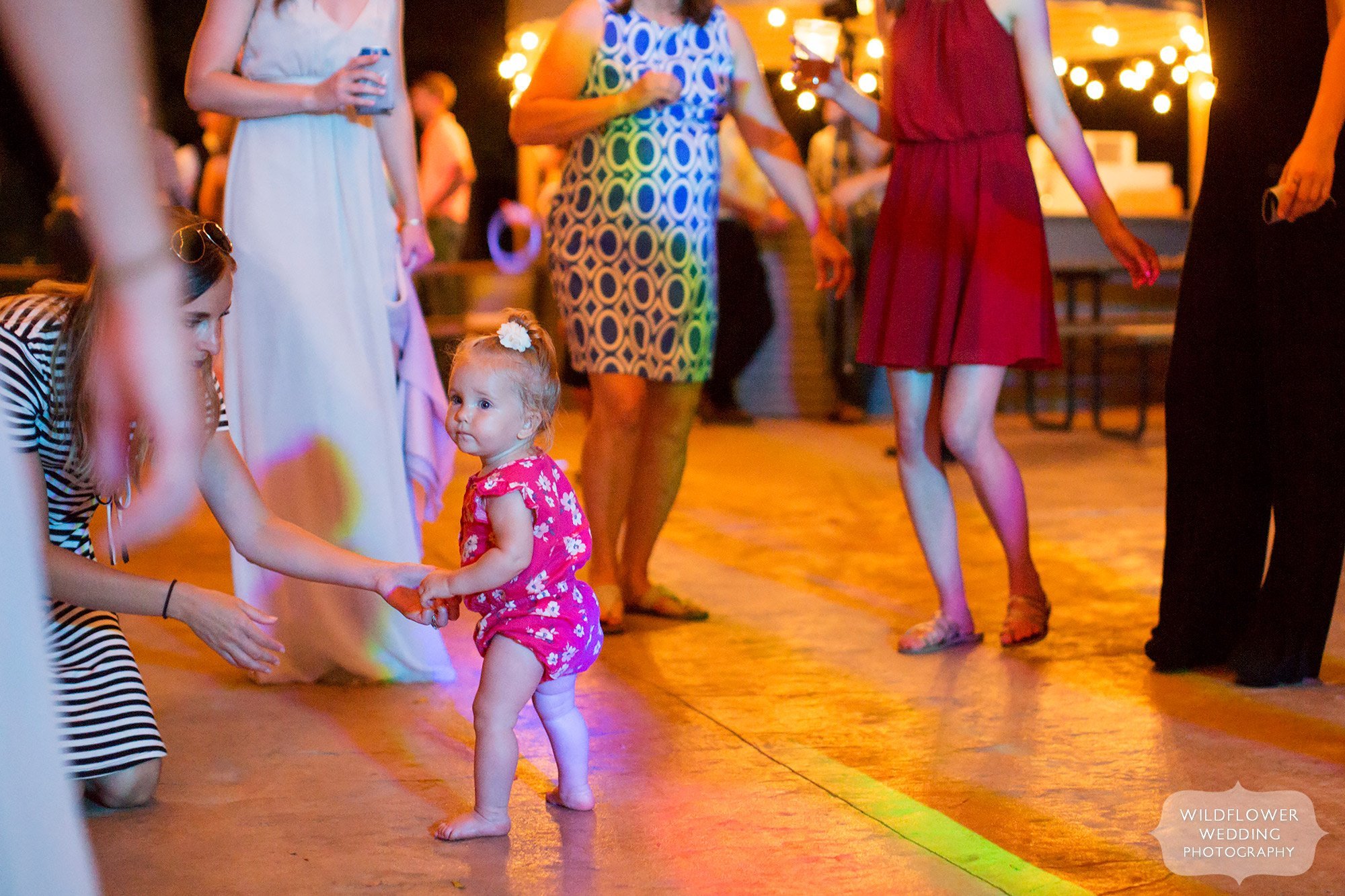 Funny photo of a little toddler girl on the dance floor at Kempker's Back 40 barn venue in southern MO.