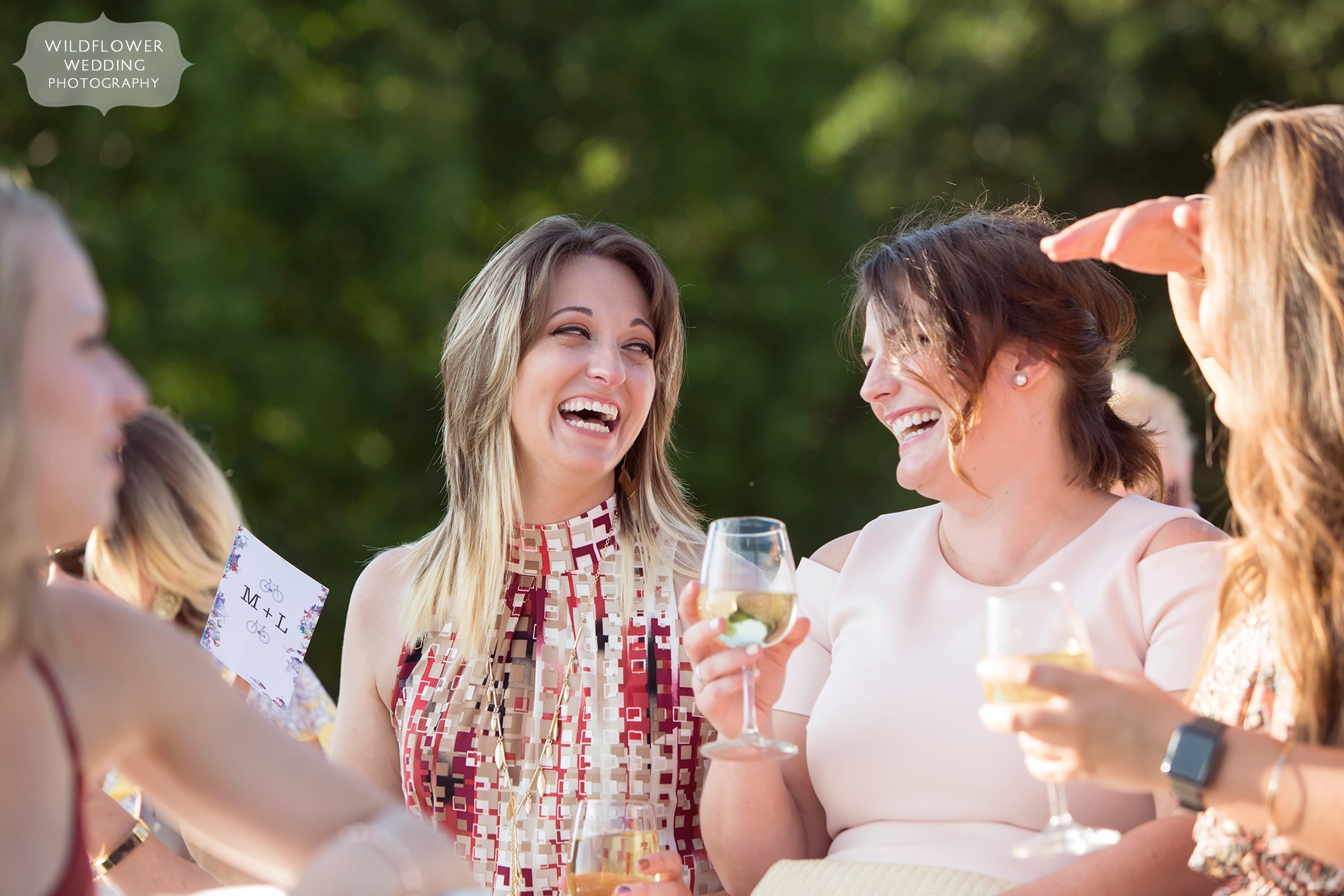 girls laughing and drinking wine before les bourgeois summer wedding