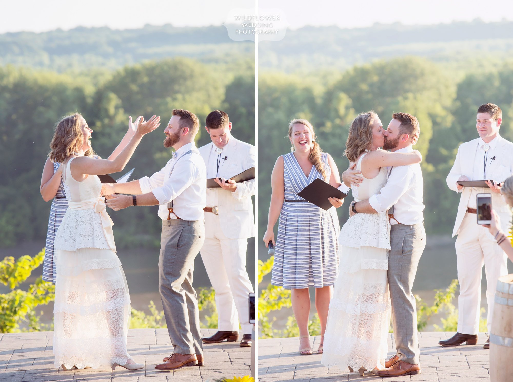 joyful wedding moment bride and groom throw hands in the air and kiss at end of ceremony