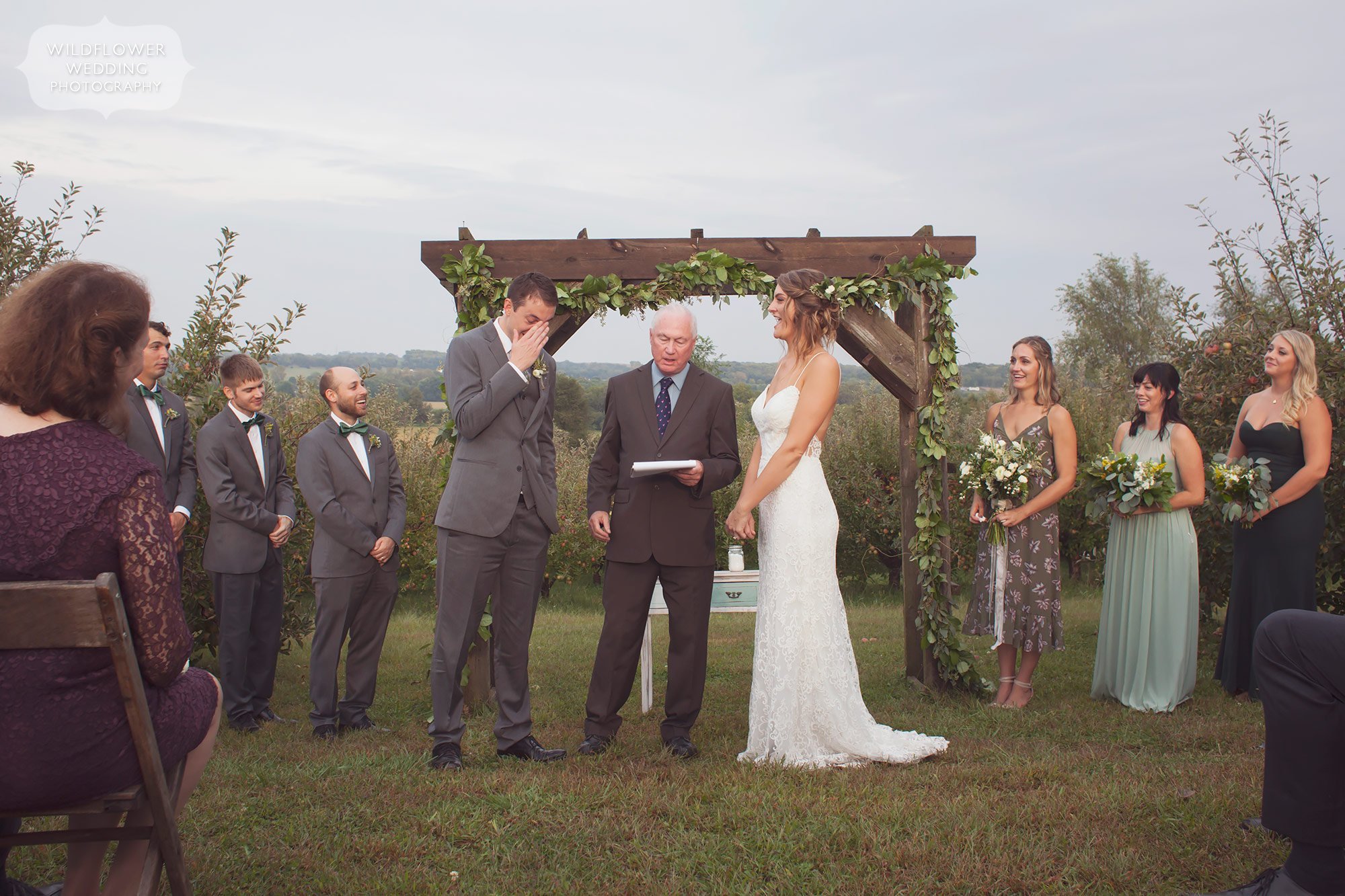 Emotional moment of the groom covering his face during the outdoor ceremony in Weston, MO.