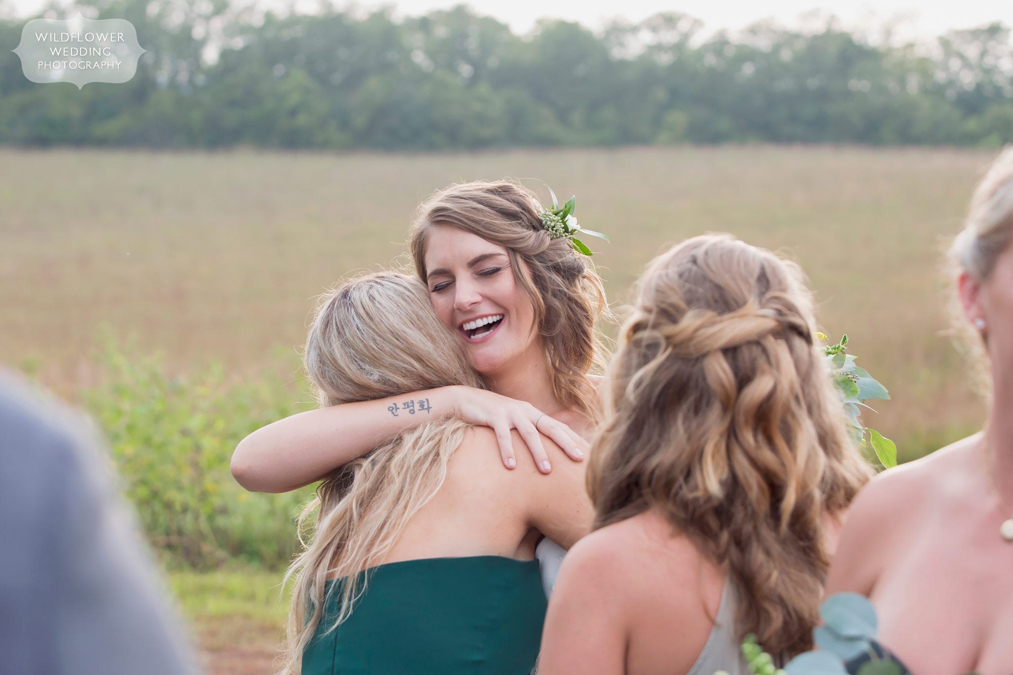 The happy bride is hugged and congratulated by her bridesmaid after the wedding ceremony.