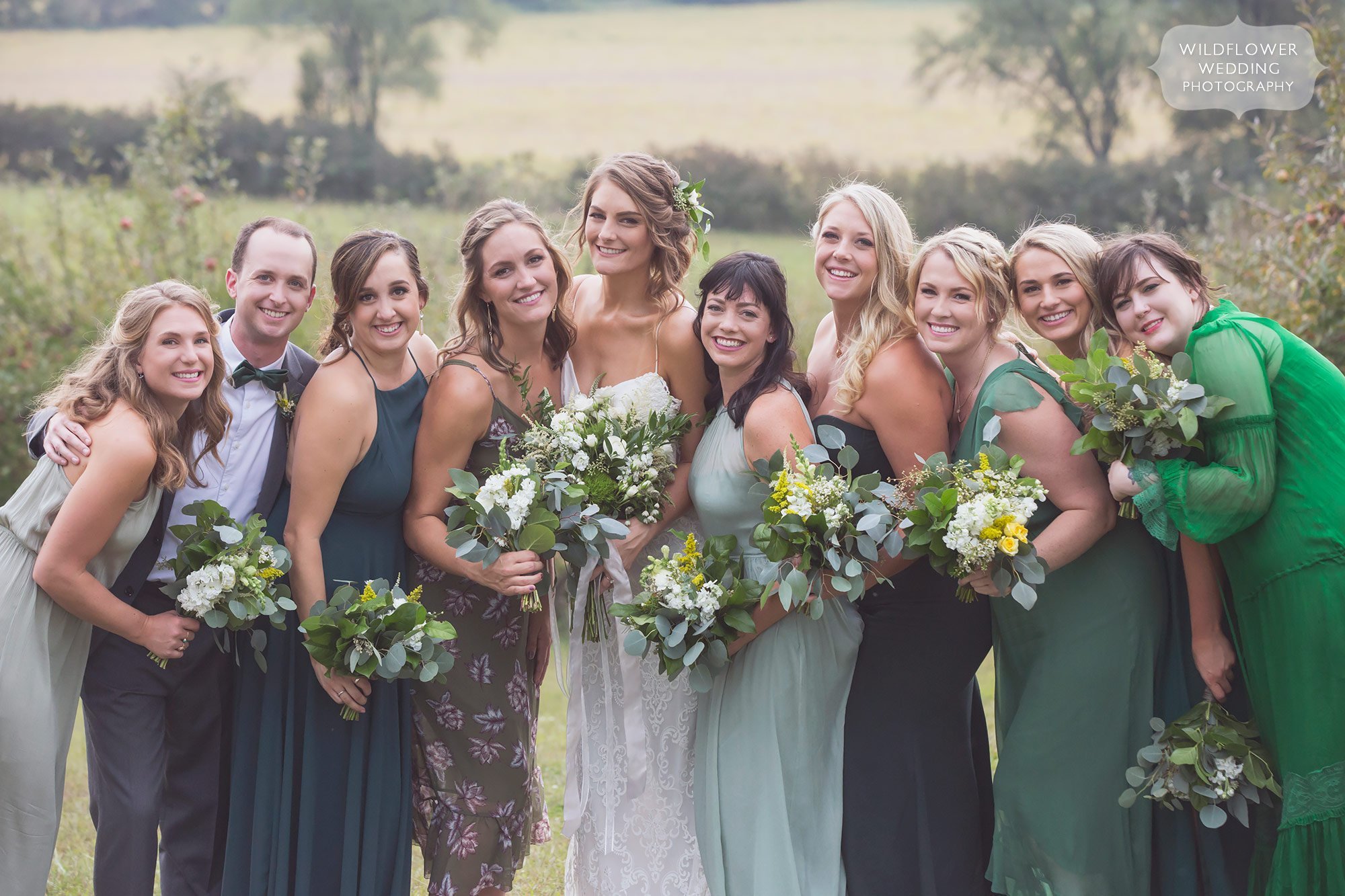 A large group of bridesmaids pose for a photo at this Missouri barn wedding.