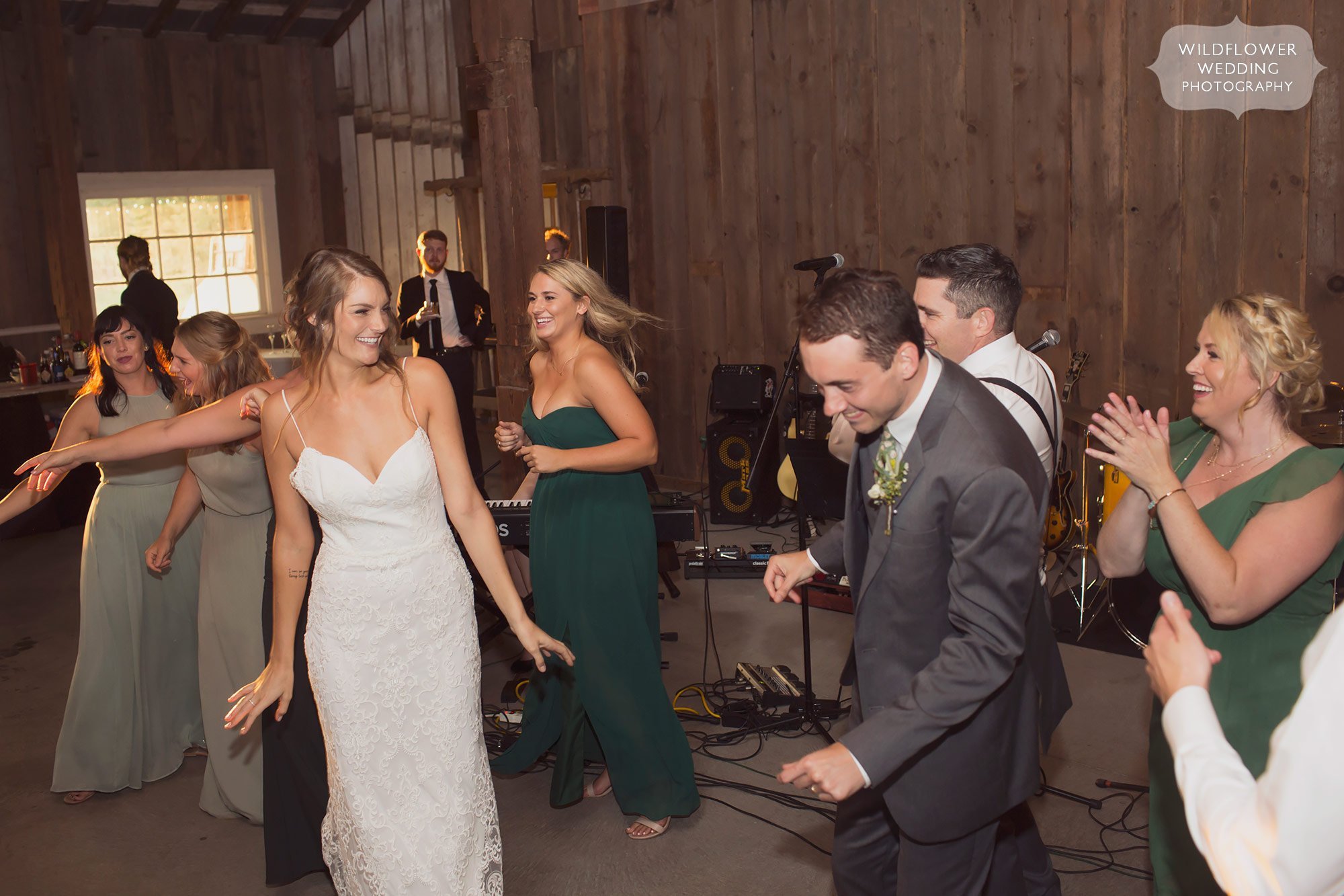 The bride and groom perform a choreographed dance with their wedding party during introductions at the Weston Red Barn.