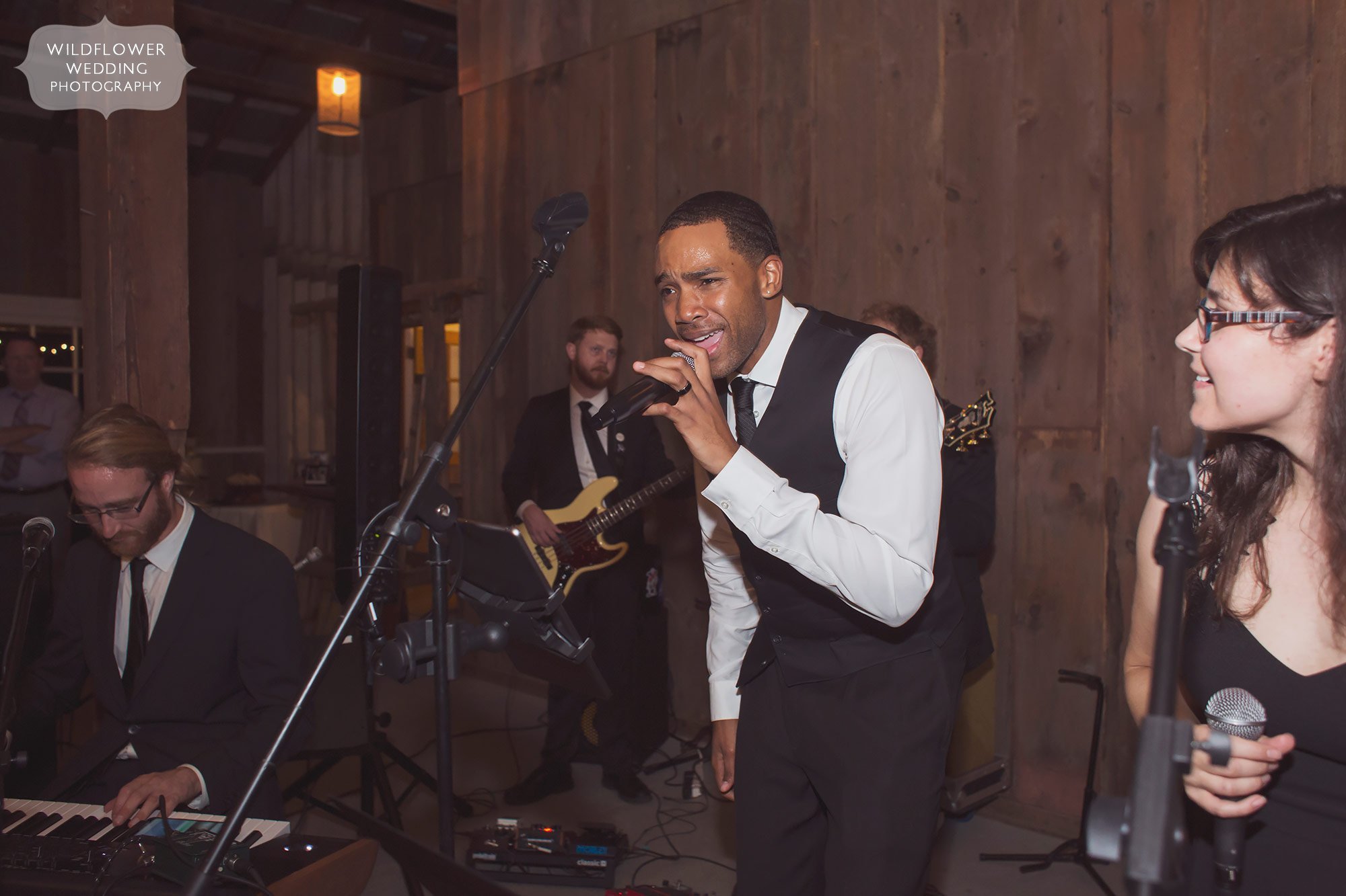 A live band performs in the barn for this rustic Weston, MO wedding reception.