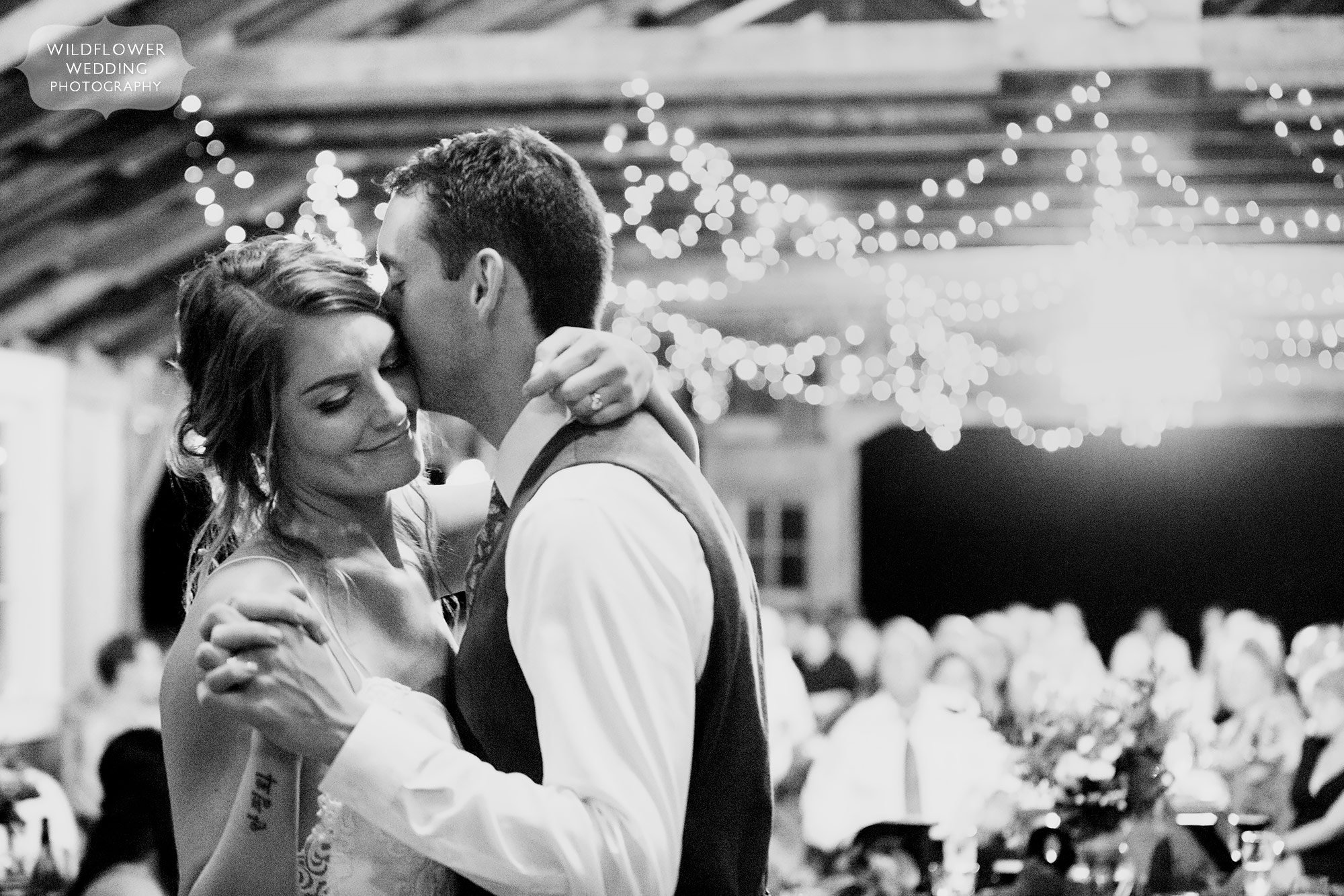 Romantic moment in black and white of the bride and groom dancing in the barn at the Weston Farm.