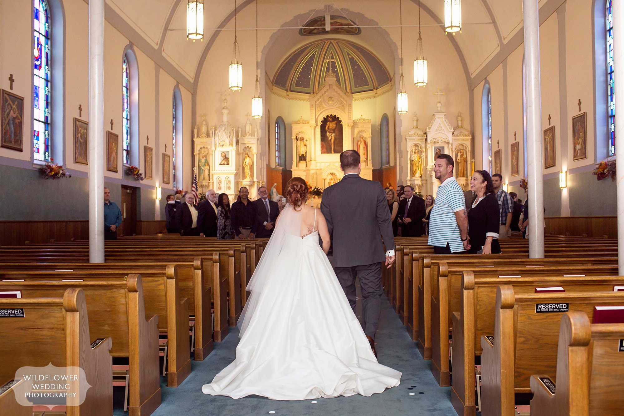 Bride and groom enter the St. Francis Xavier Church for their wedding ceremony in Jeff City.