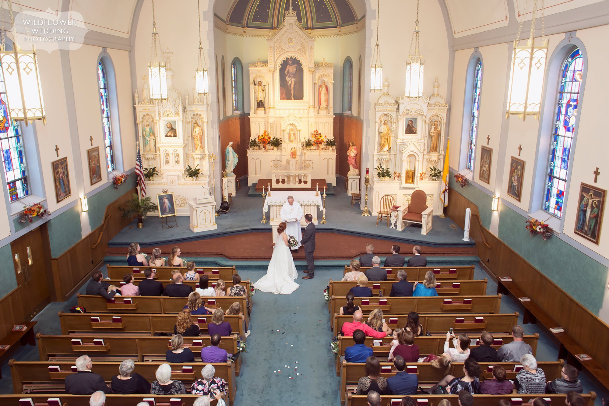 Inside view of a wedding ceremony at the St. Francis Xavier Church in Jeff City, MO.