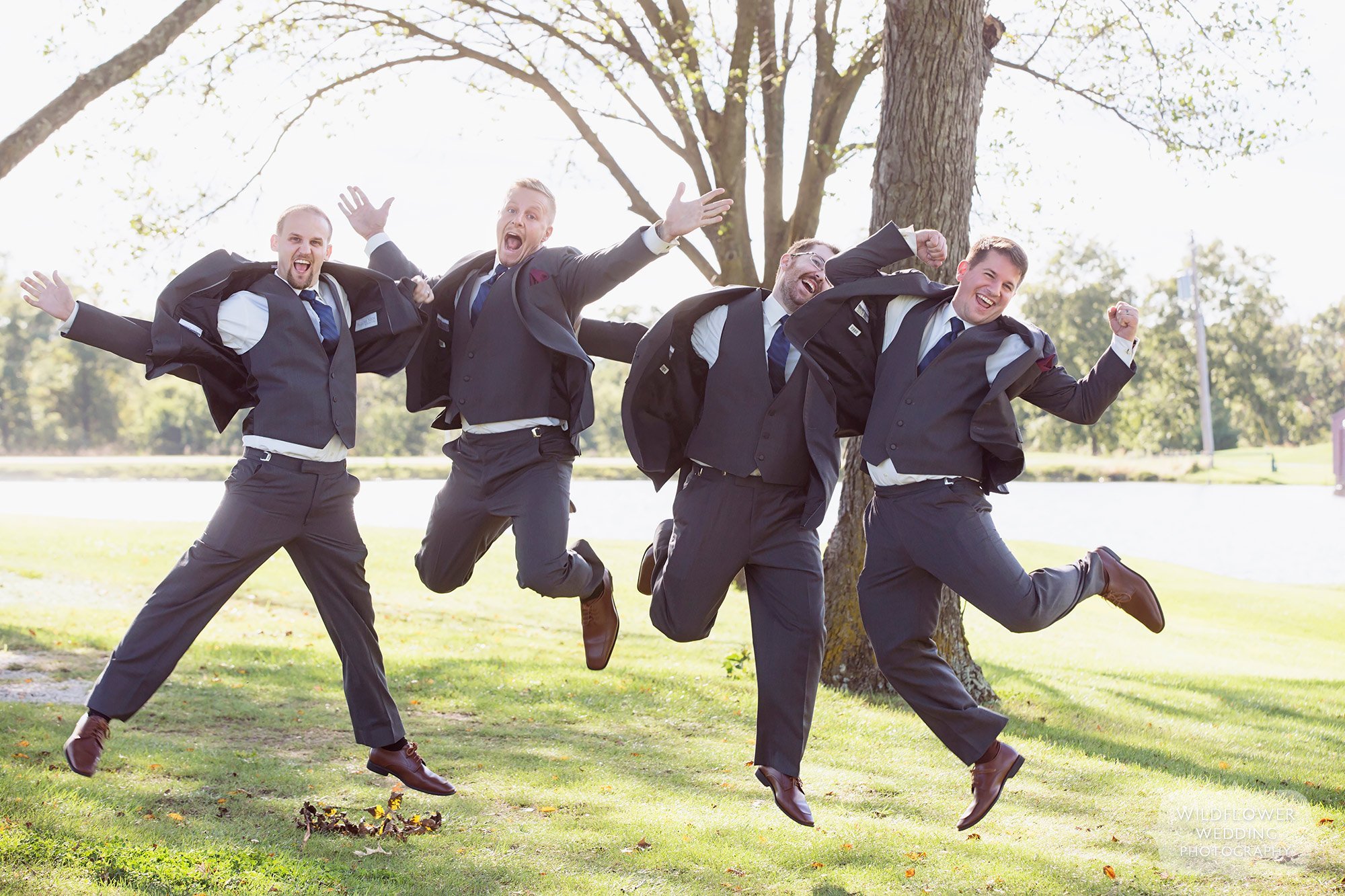 Groomsmen jumping high in the air at the Jefferson City Country Club.