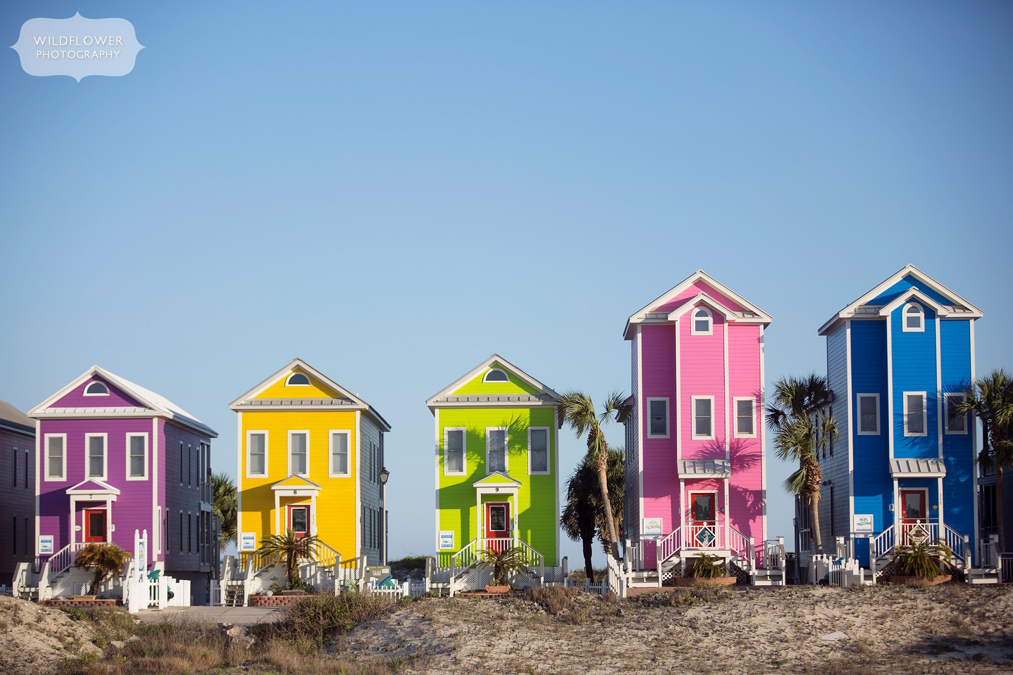 Rainbow houses in purple, yellow, lime green, pink and bright blue on St. George Island in Eastpoint, FL.