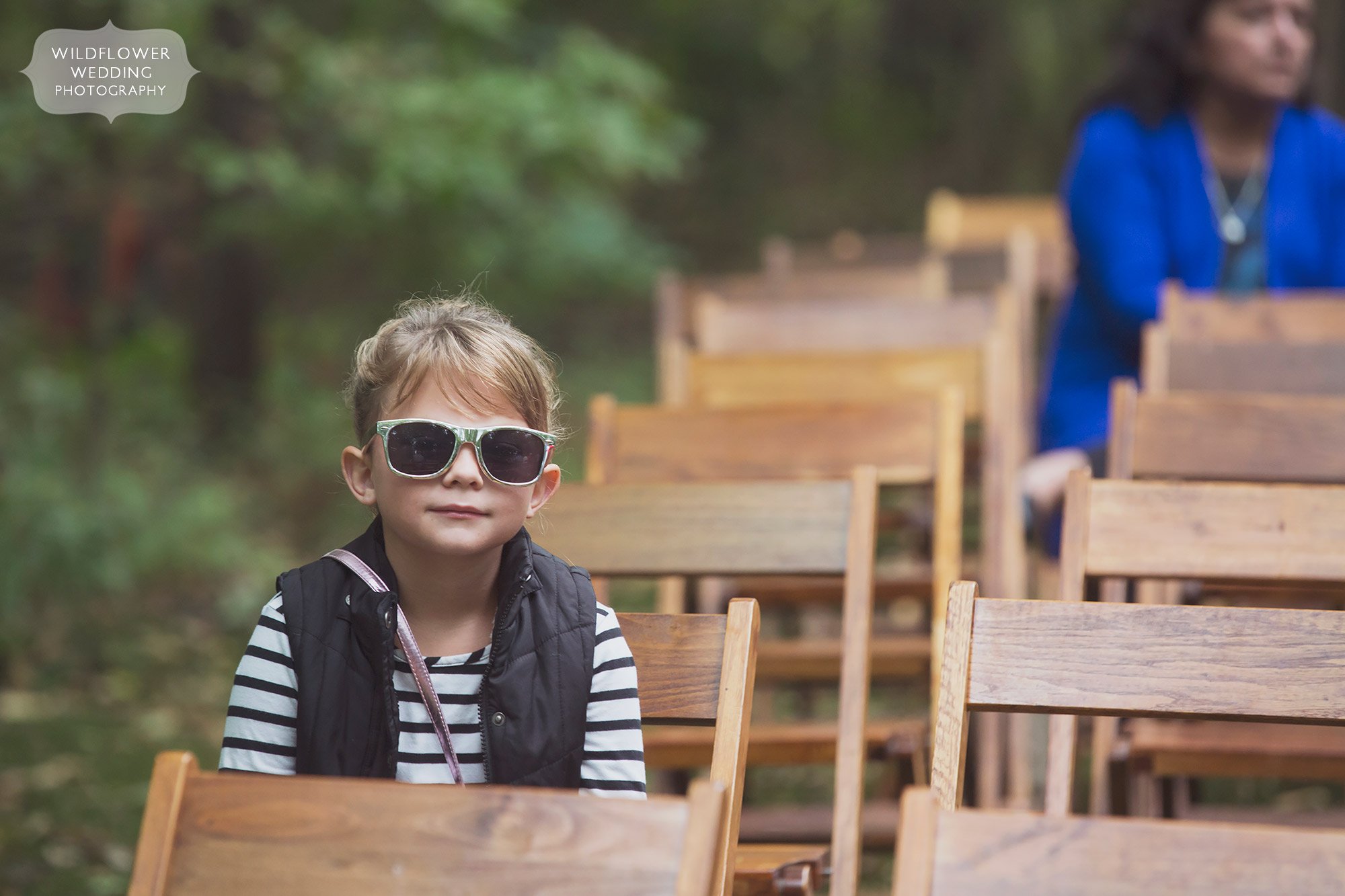 Funny photo of kid in sunglasses as wedding guest at Schwinn Barn in KS.