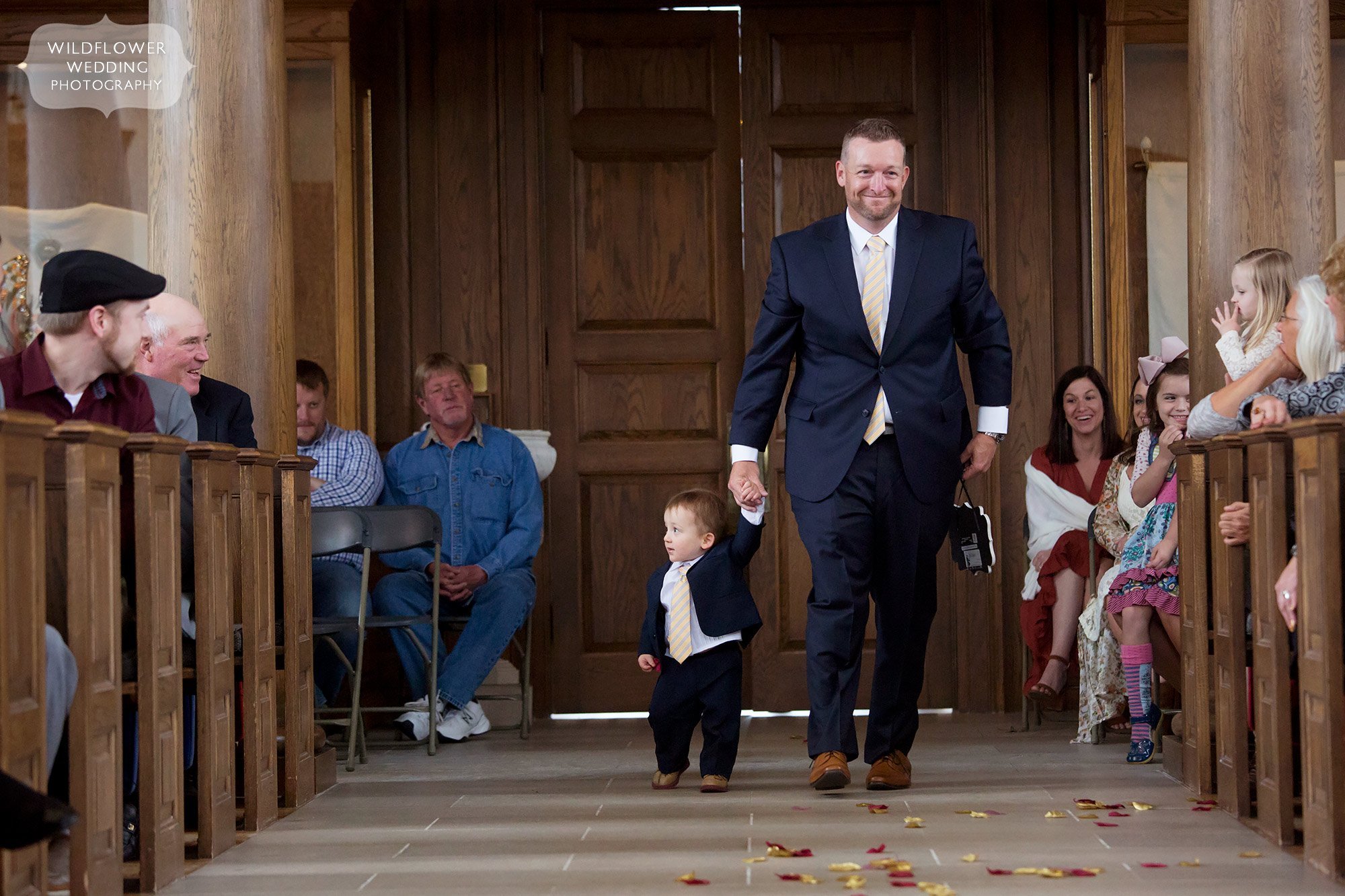 The ring bearer walks down the aisle at St. Mary's Church in Fulton, MO.