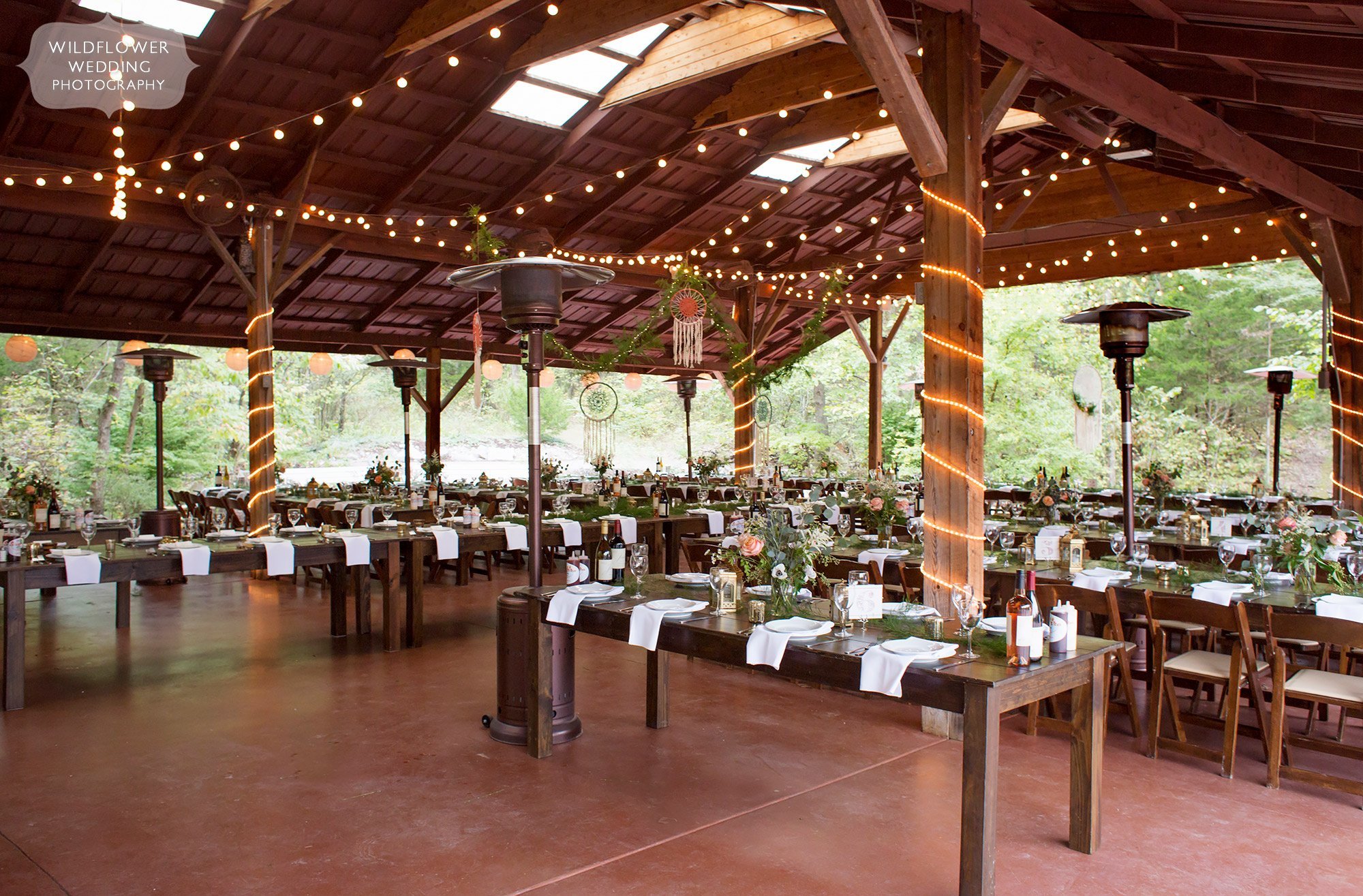 View of the inside of the Little Piney Lodge wedding pavilion with twinkle lights.