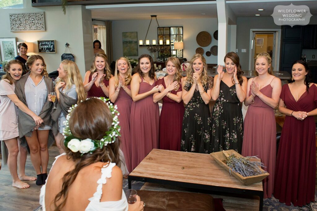 The bridesmaids have their first look at the bride in her dress in Hermann, MO.
