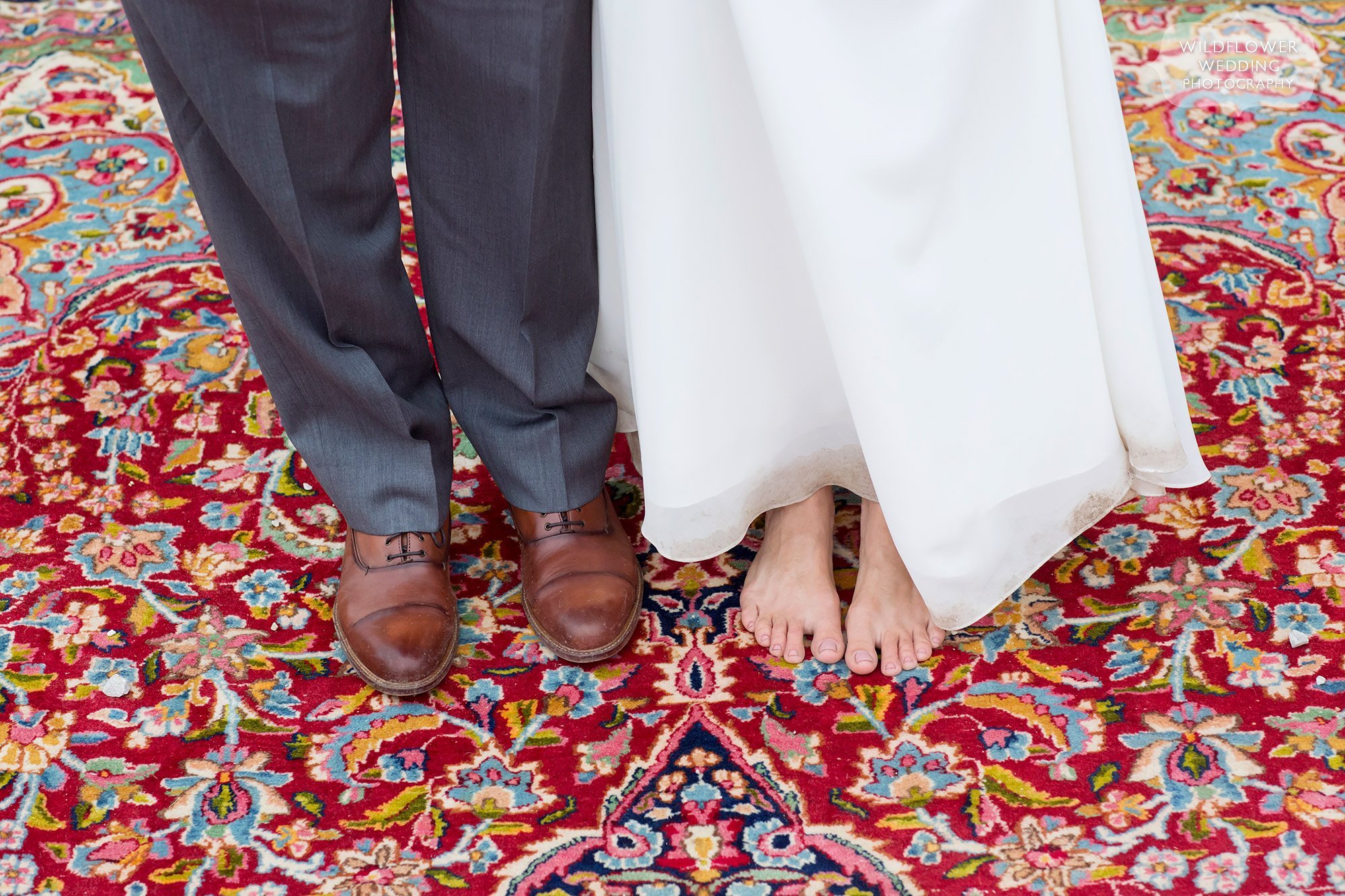 A barefoot bride stands on the persian rug at this boho wedding at Little Piney in Hermann.