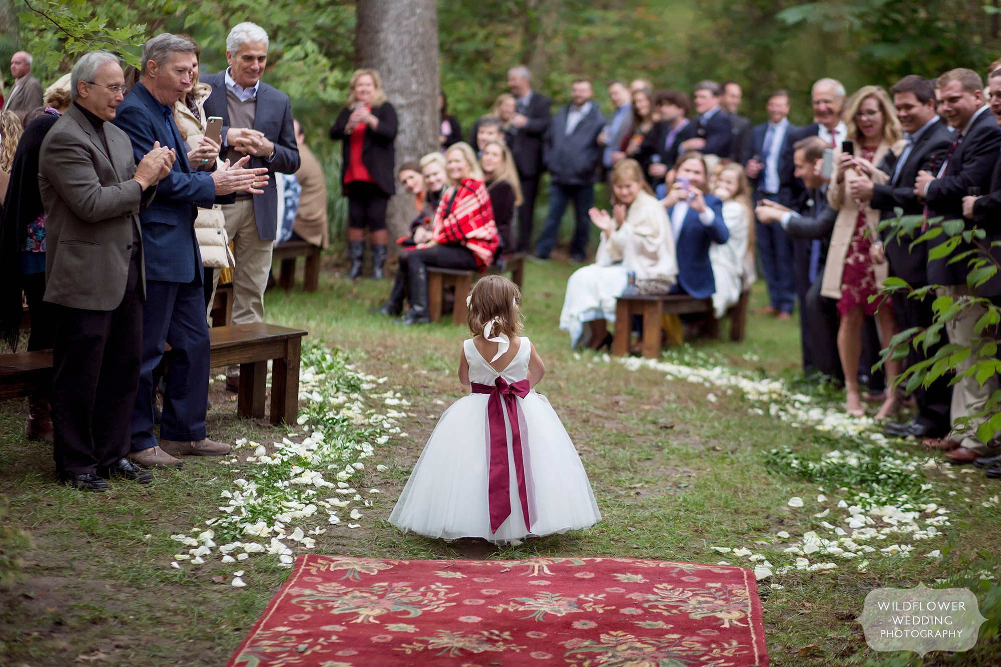 Flower girl walks down aisle at this boho wedding ceremony at Little Piney.